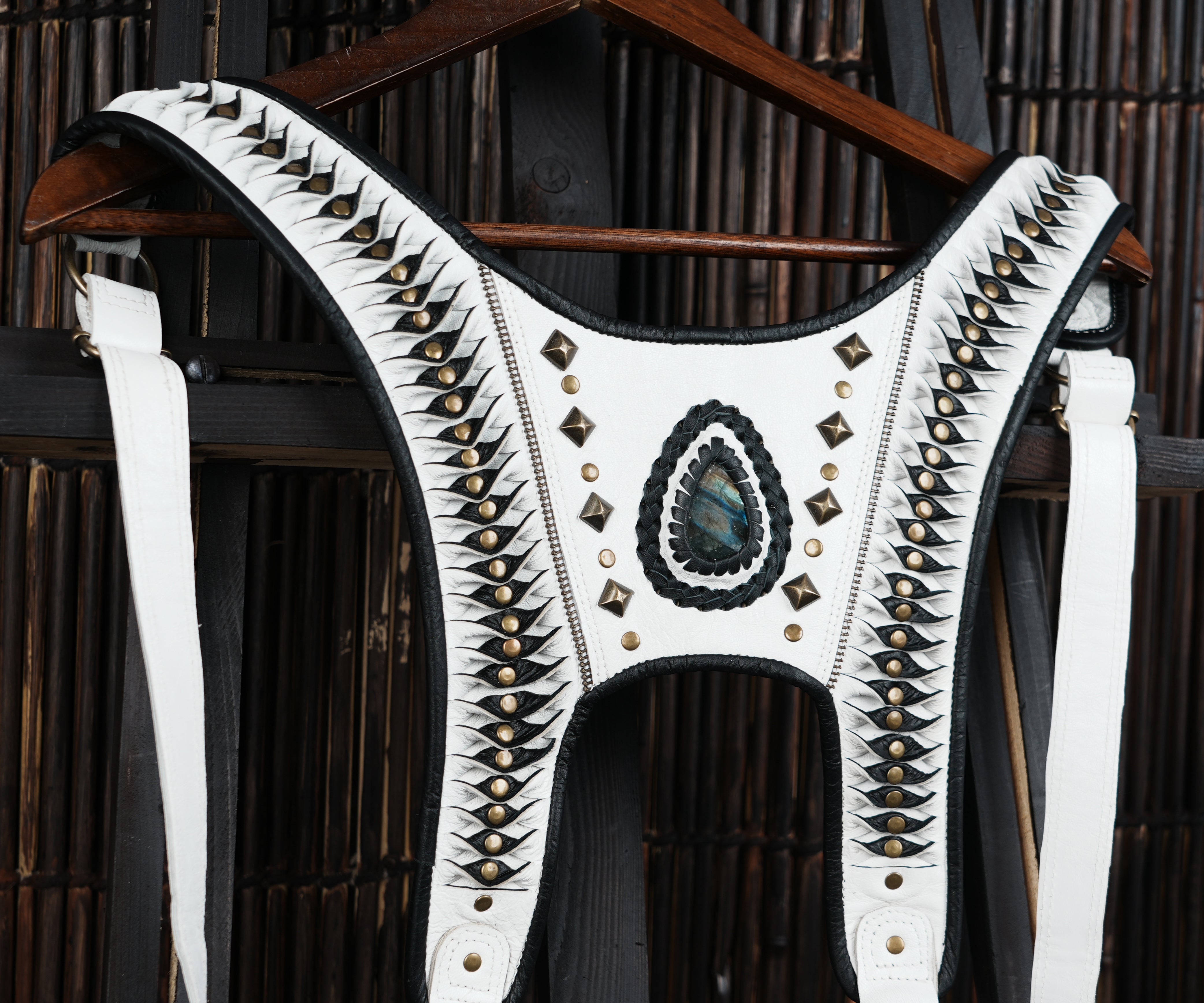 White leather shoulder harness with tribal patterning