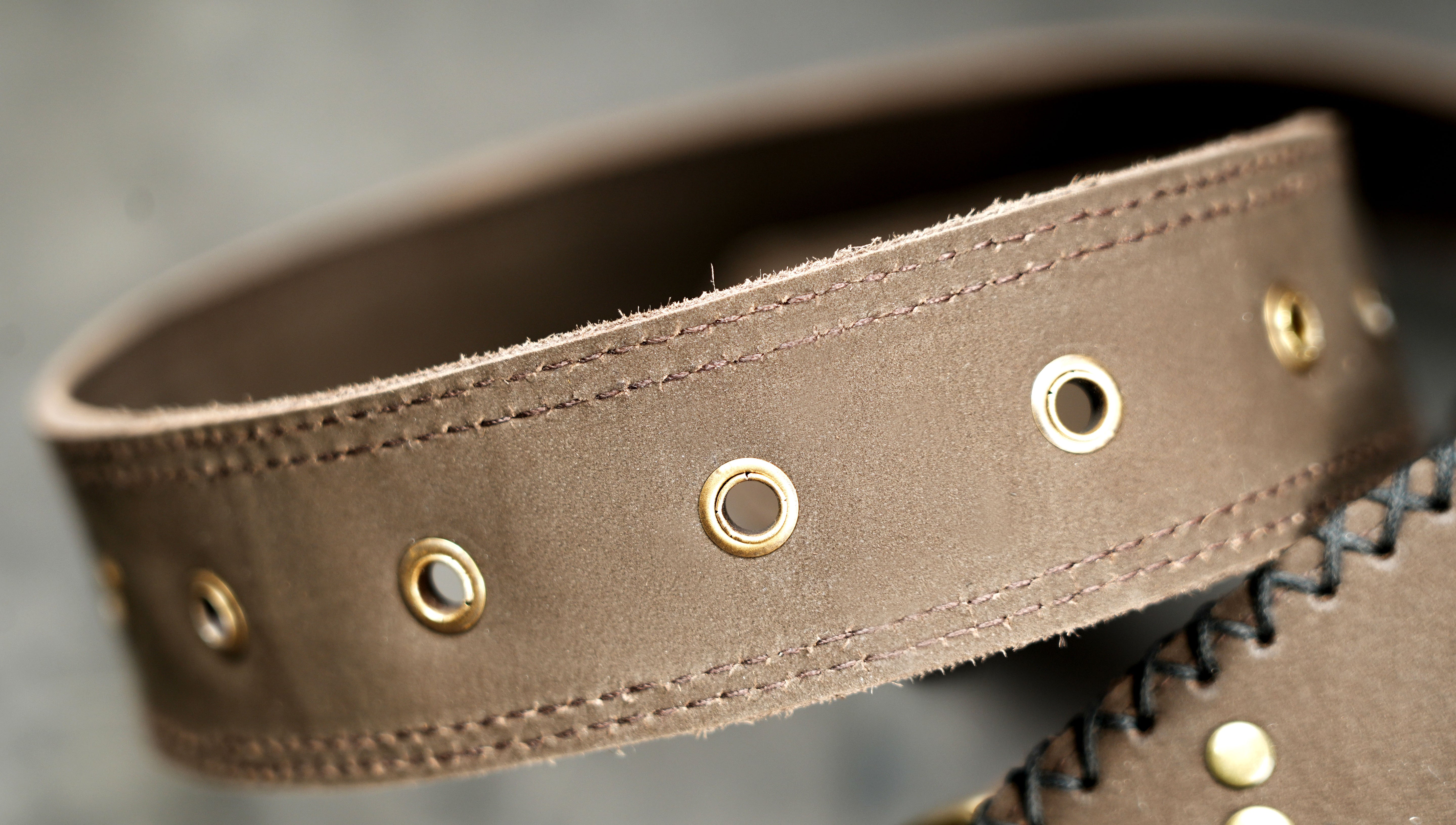 Brown leather waist bag featuring brass hardware and gemstone