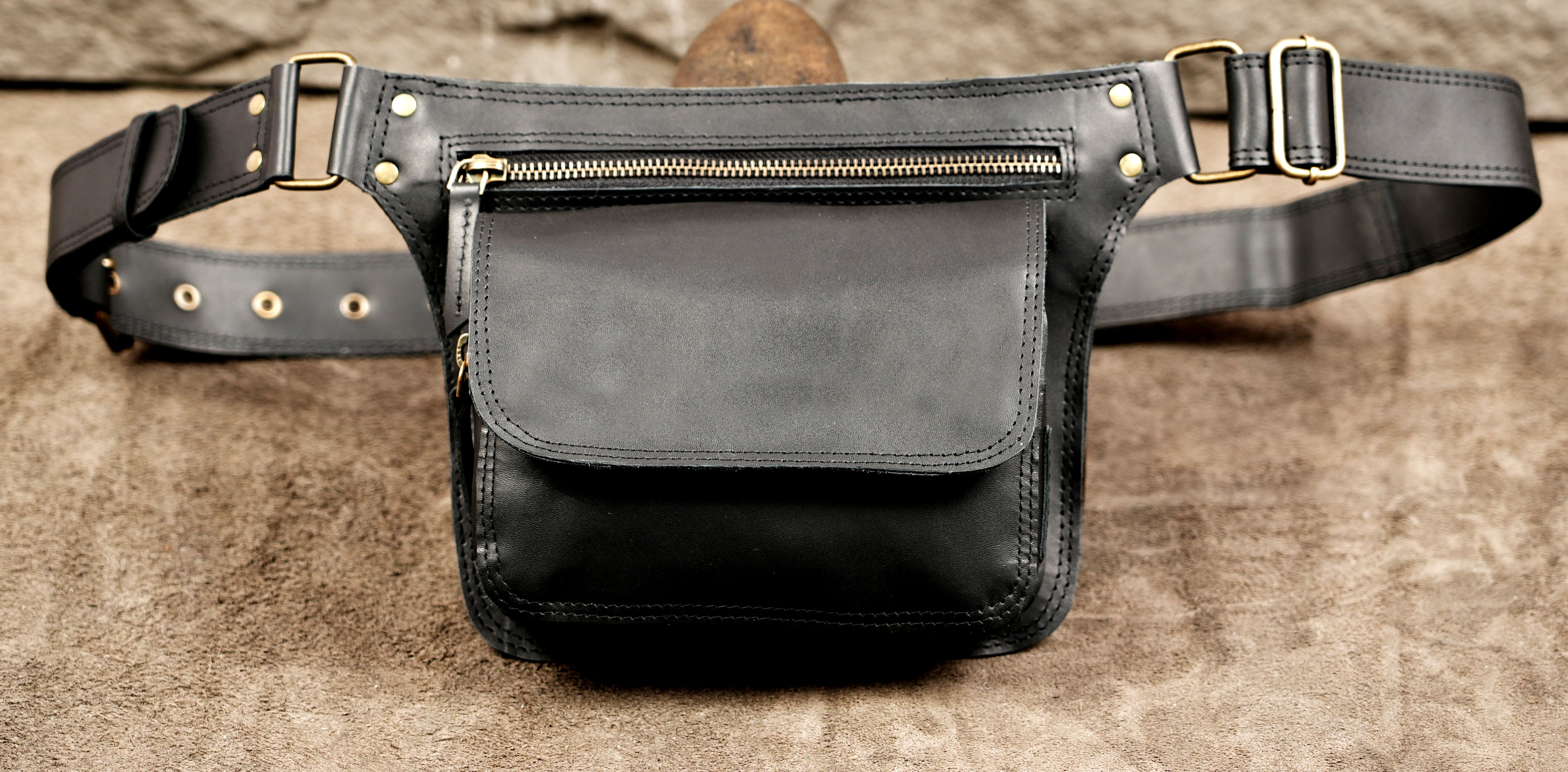 Genuine leather waist bag with zipper pocket and flap closure