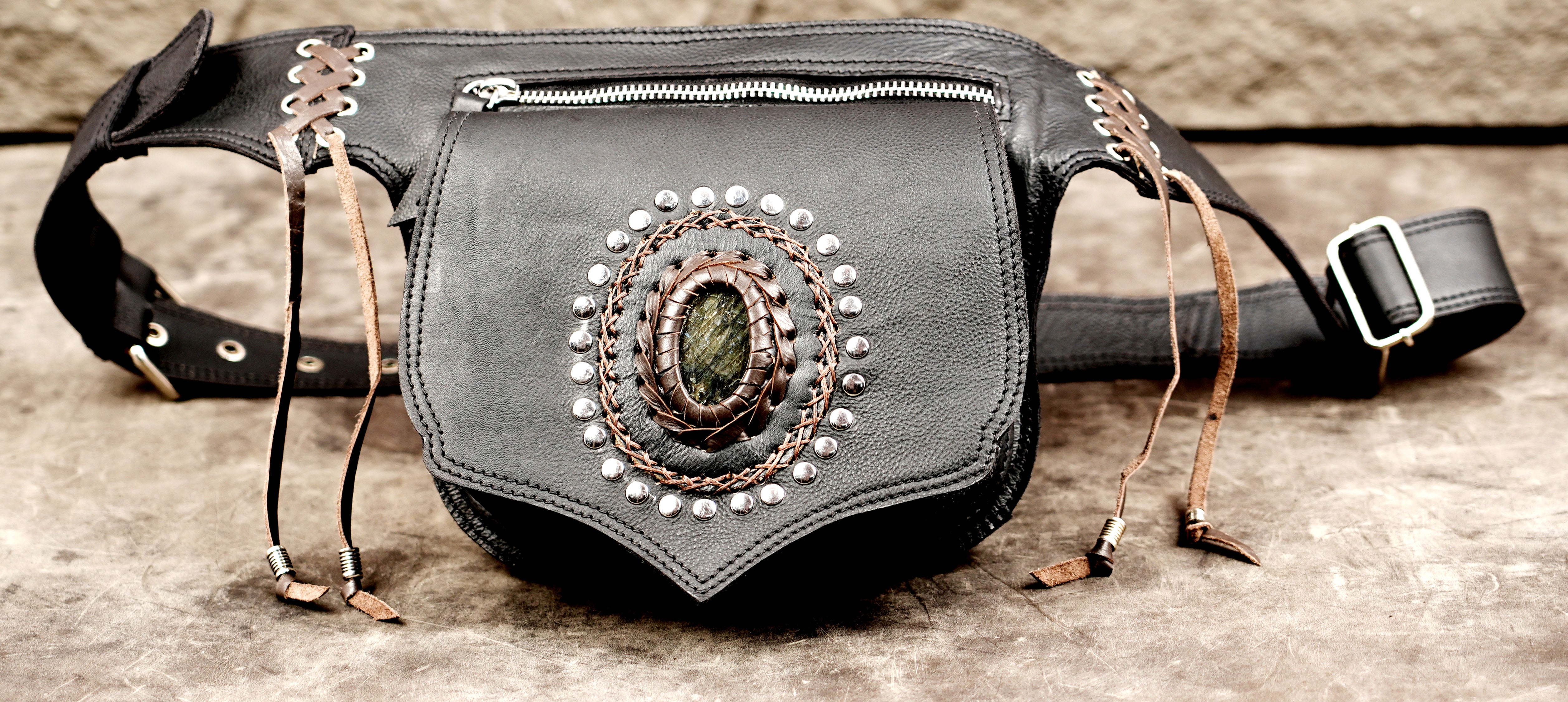 Biker style black leather waist pouch with heavy silver studs and a crystal centerpiece.