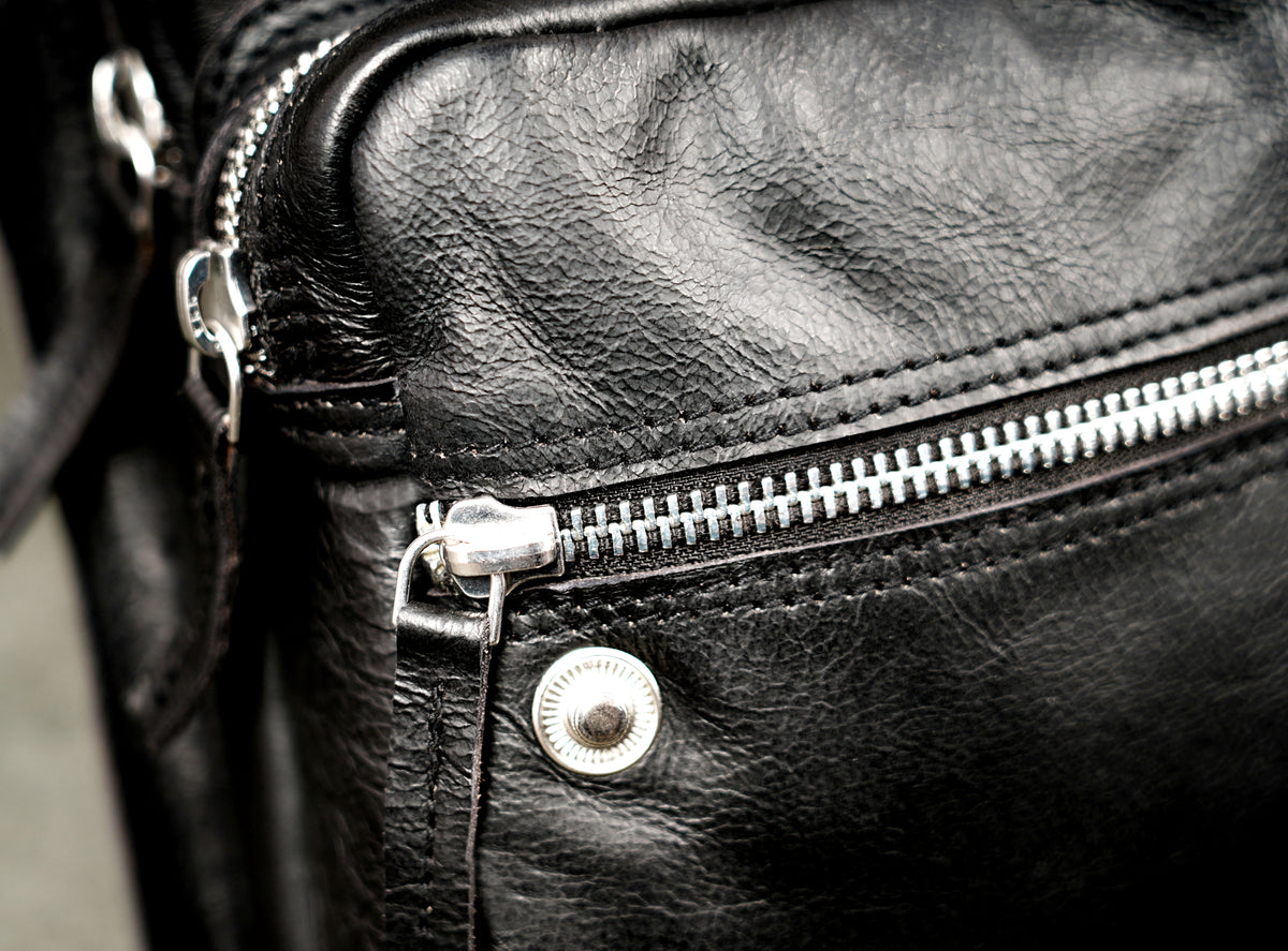 Sleek leather waist bag with snap button flap