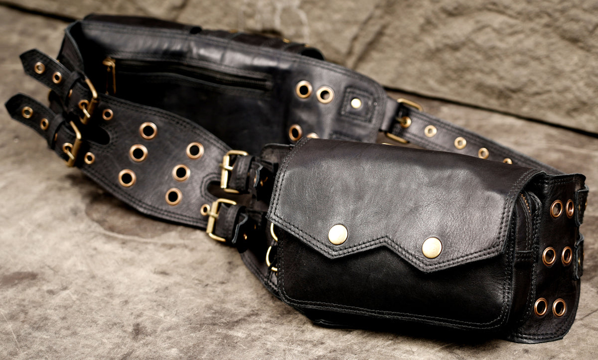 Black leather waist pack with wide shaped panels and buckle adjustments.