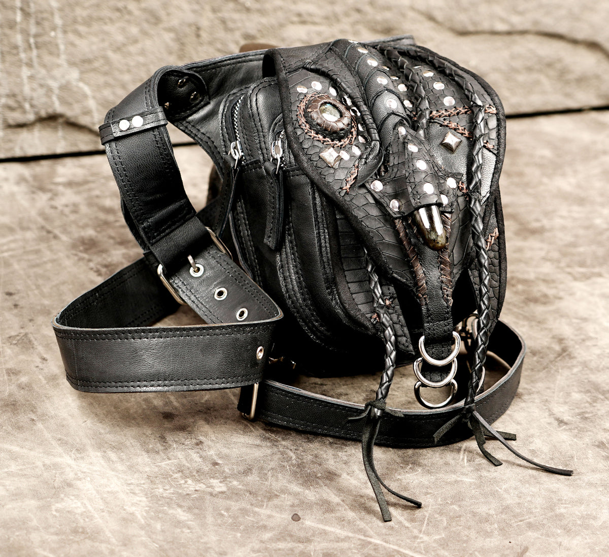 Alternative fashion black leather belt bag with braided accents