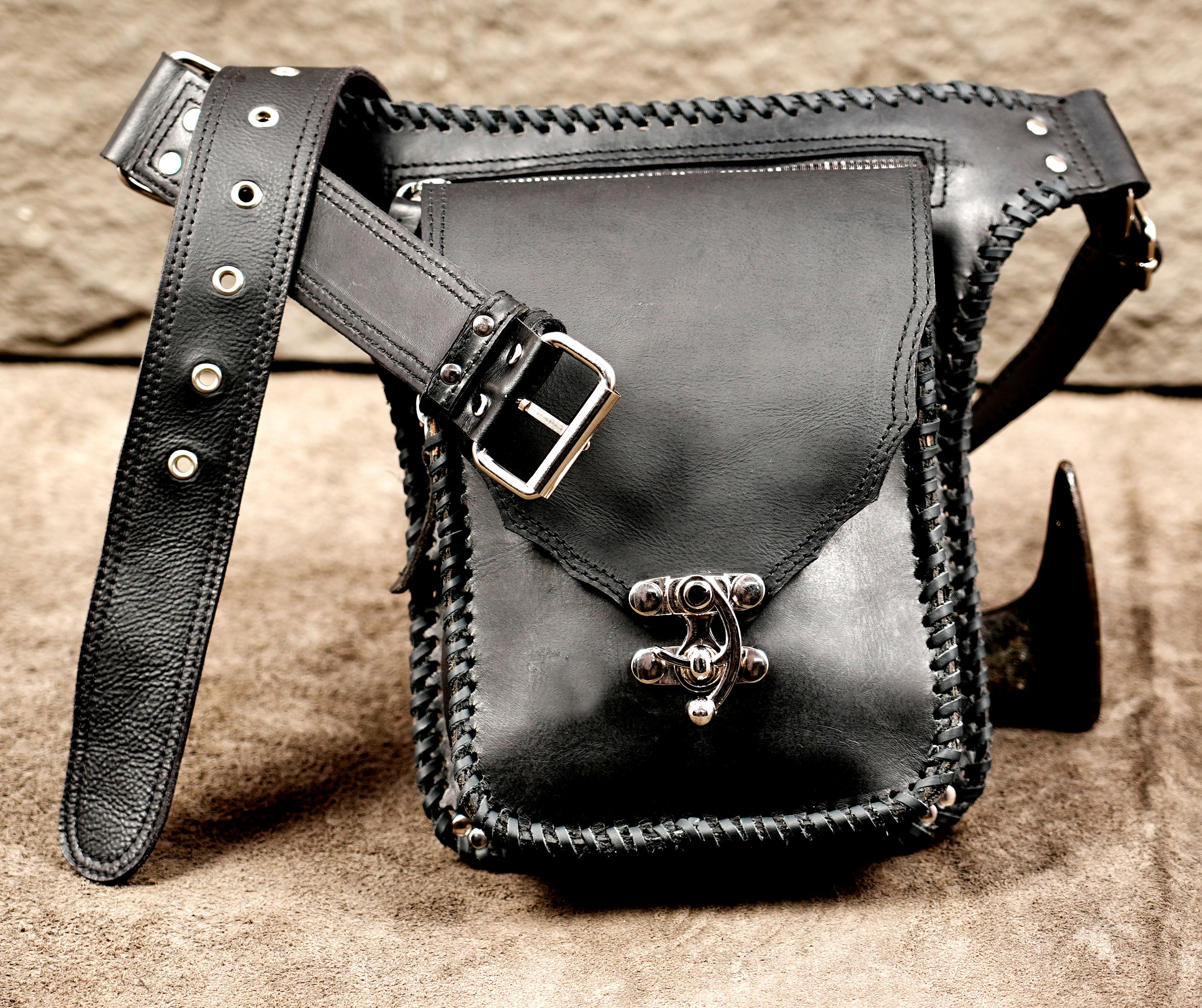 Tactical black leather waist pouch with secure silver metal clasp.