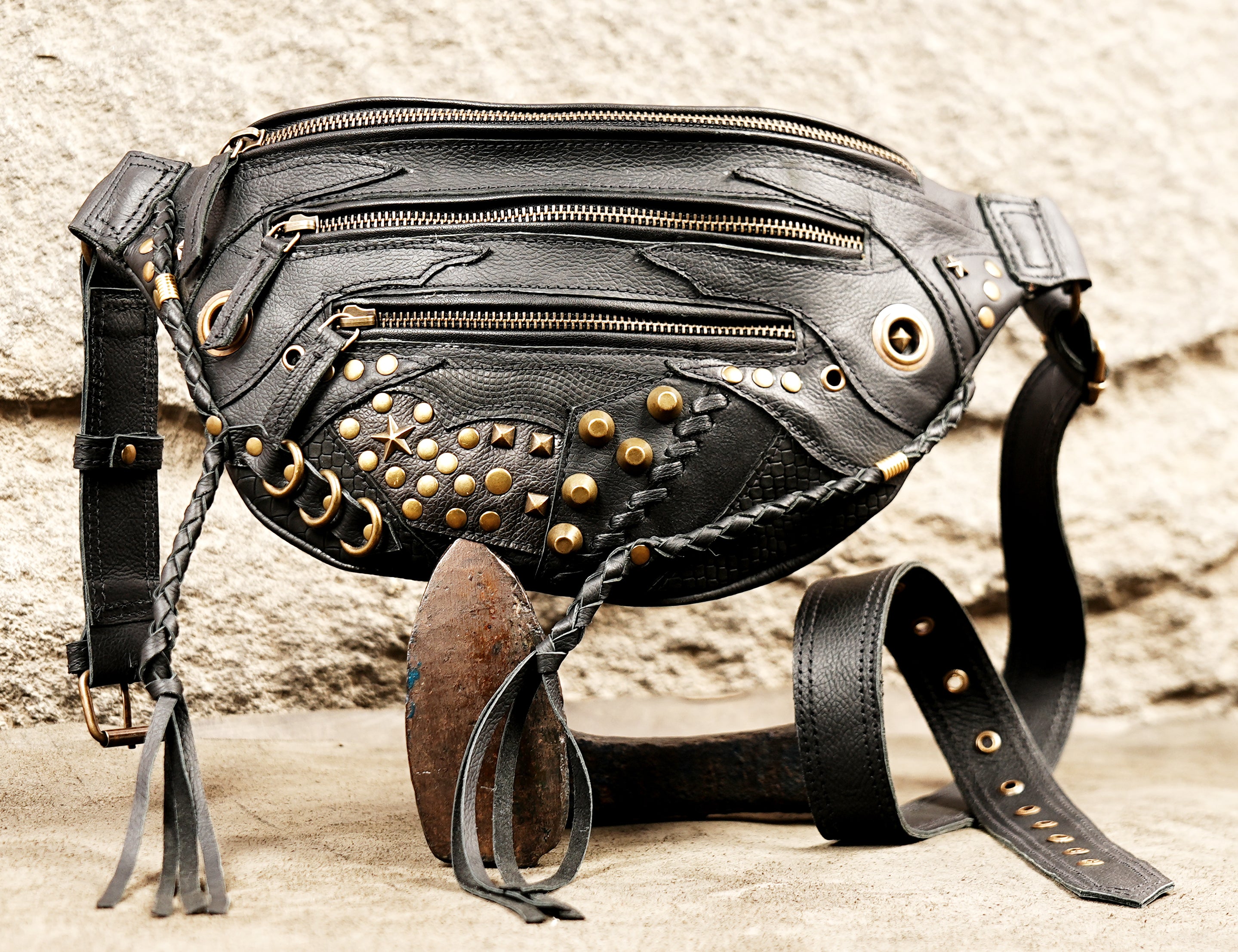 Adjustable black leather waist holster bag with three front zippers and gold stud decorations.