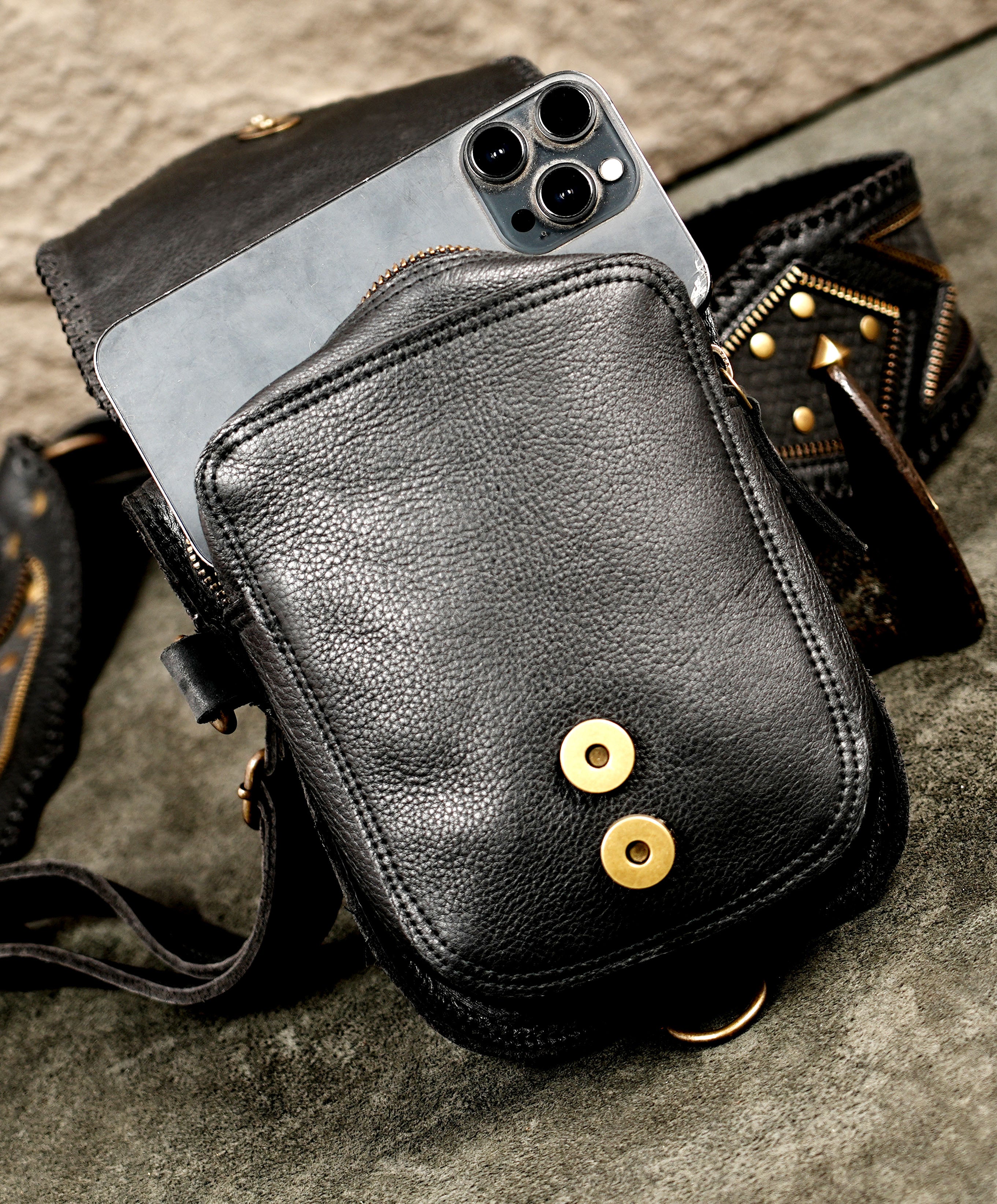 Alternative fashion black leather body harness featuring twin front utility bags for a bold, hands-free look