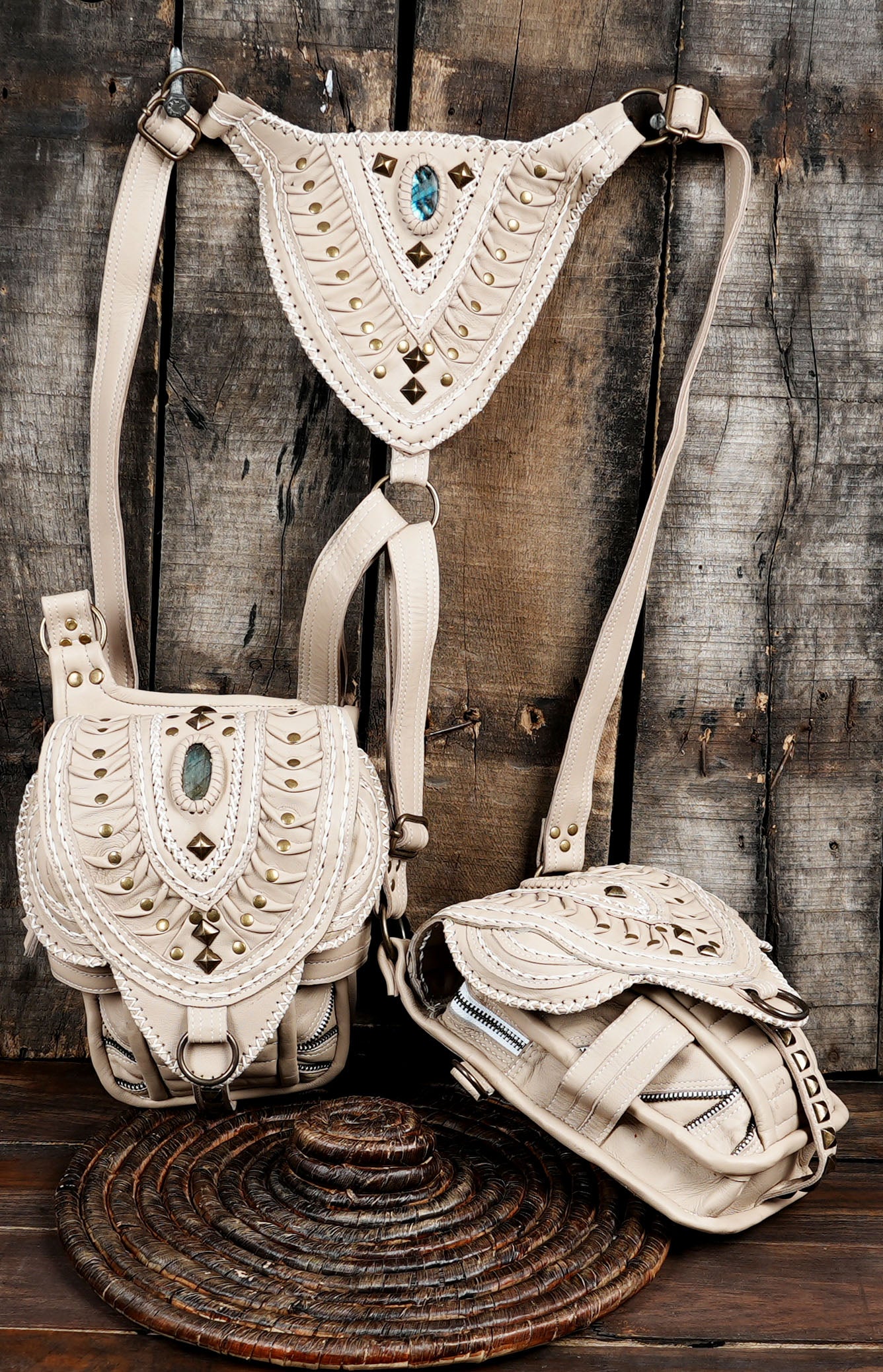 Two-pocket cream leather shoulder holster utility belt with sturdy metal clasps.