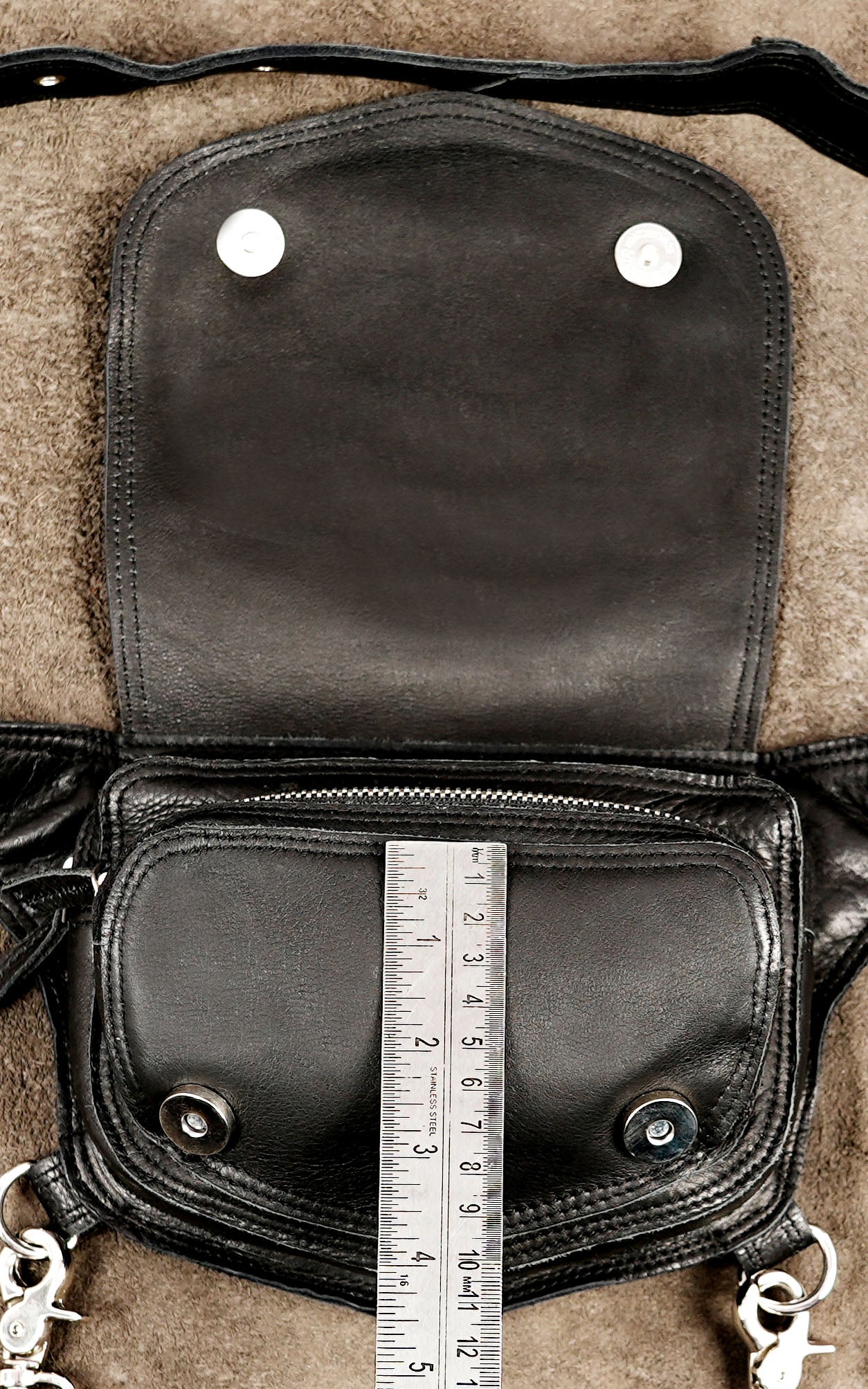 Stylish black leather utility pouch with adjustable hardware for a custom fit on any frame