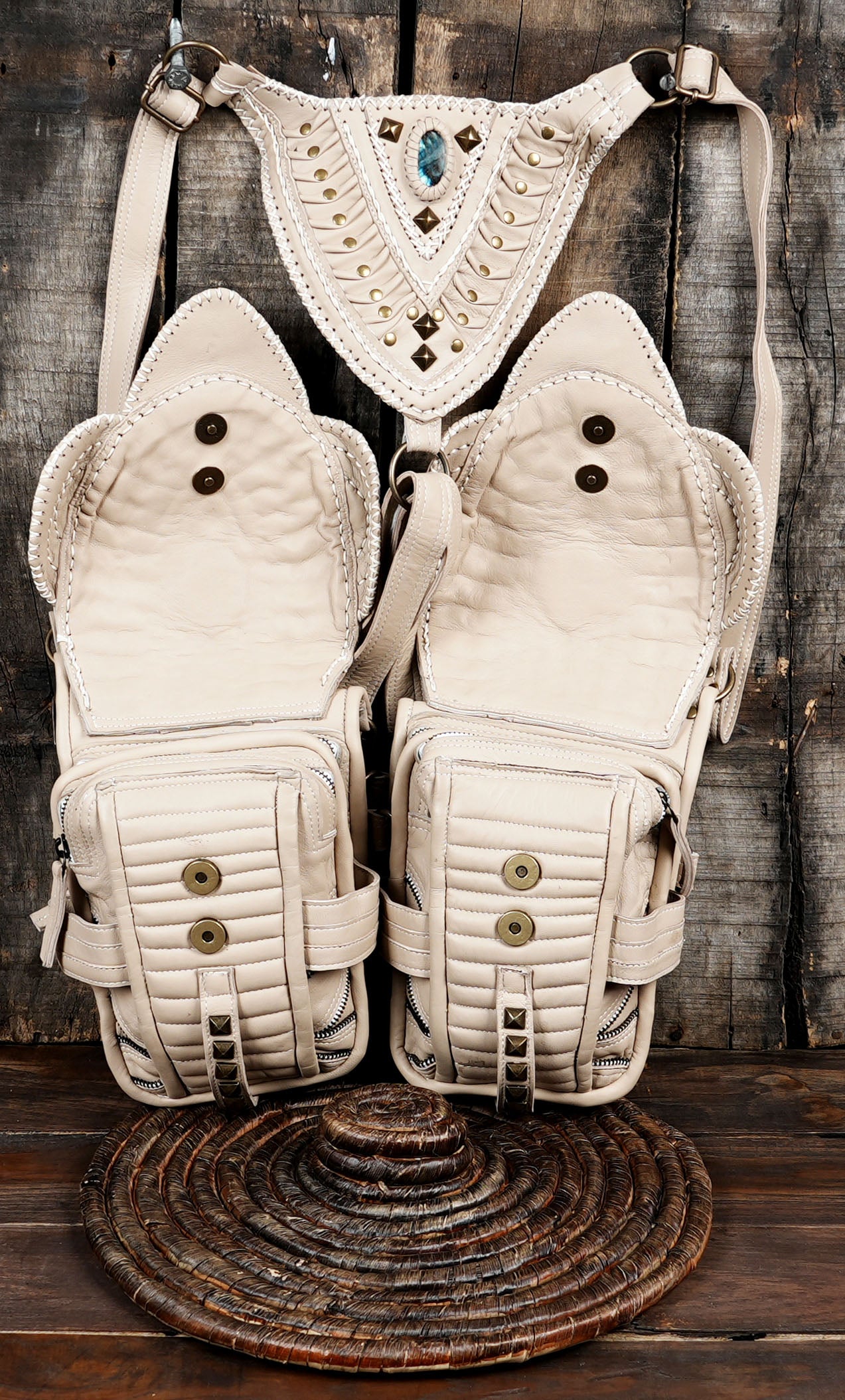 High-quality cream leather shoulder holster bag with adjustable straps and brass hardware.