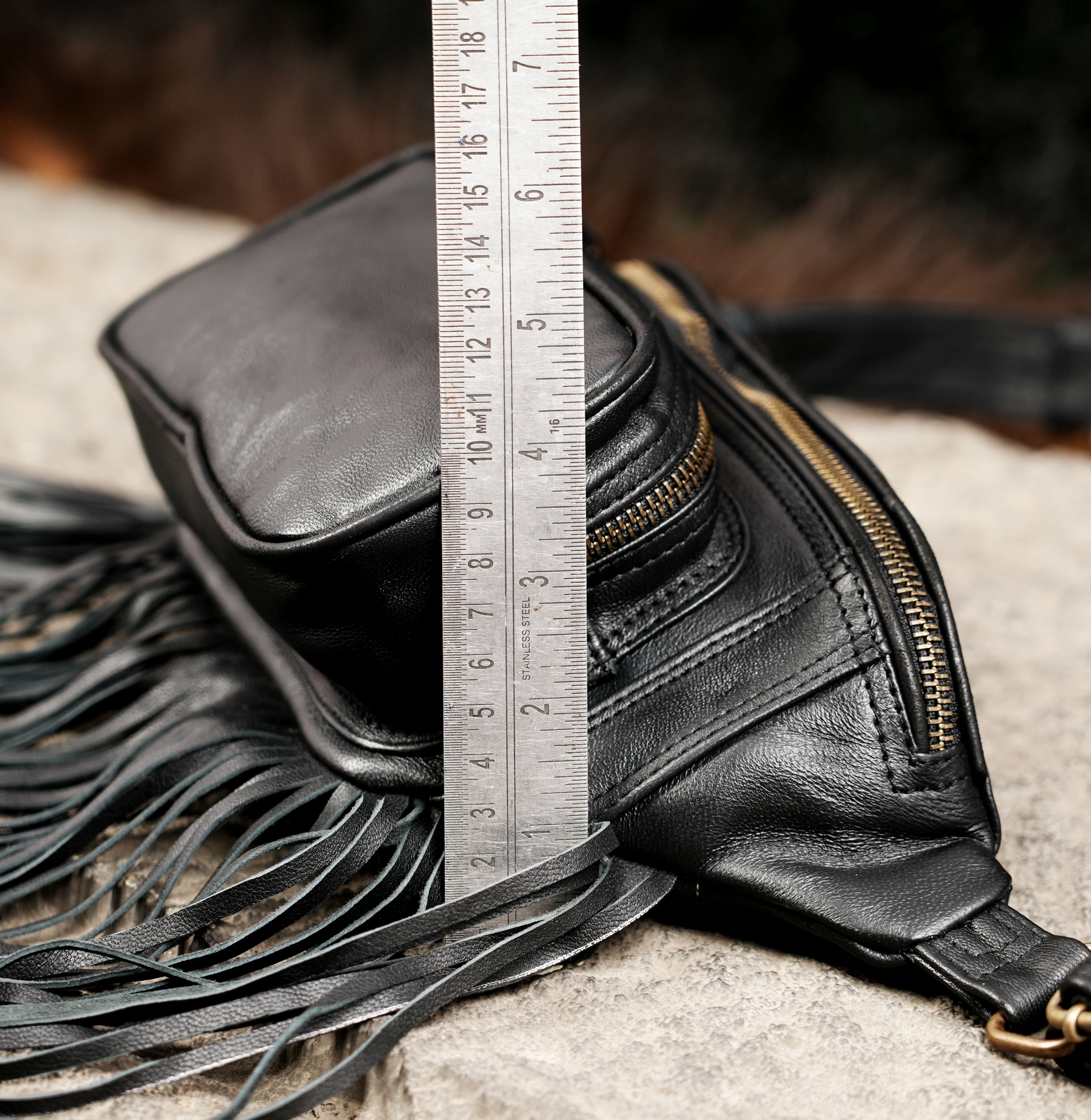 Western black leather hip bag with tassel details