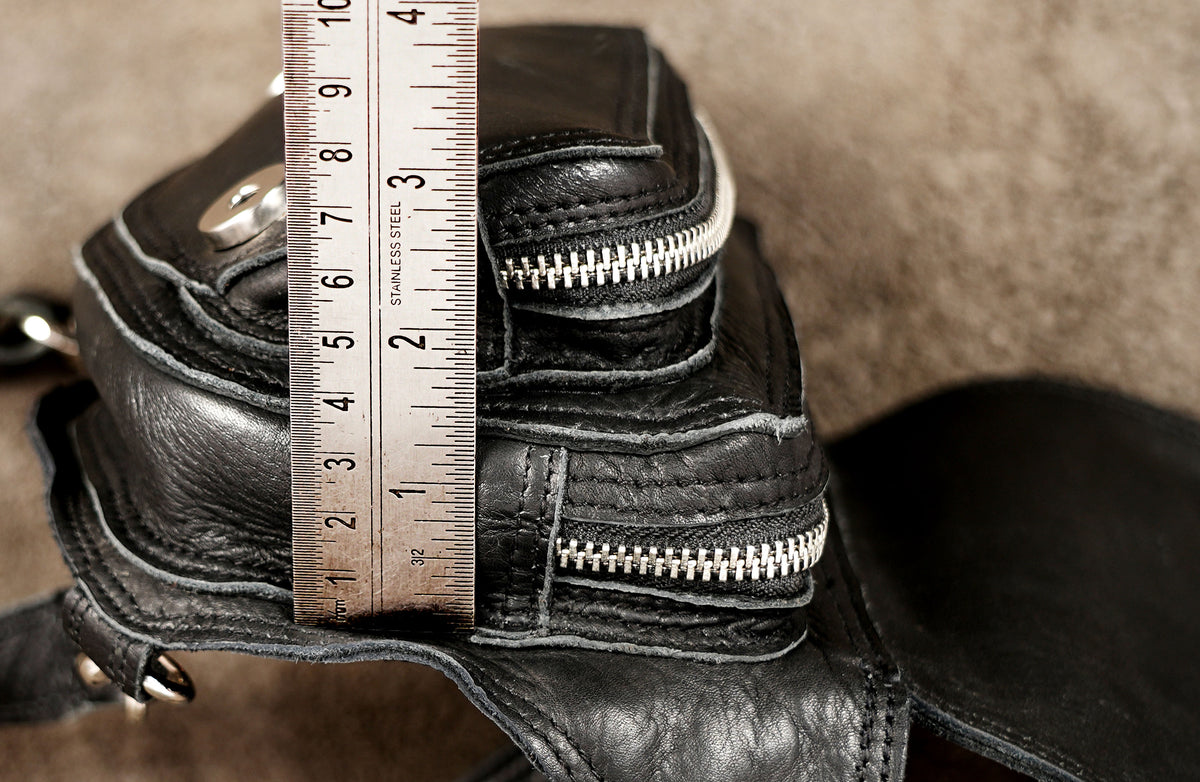 Edgy leather hip belt and leg strap assembly crafted for techno and electronic music events