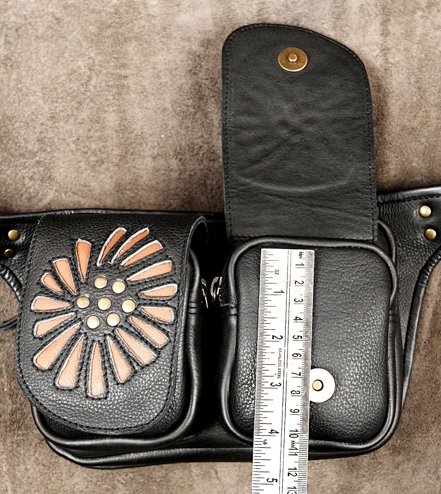 Black leather travel waist pouch with adjustable buckle and two convenient pockets.