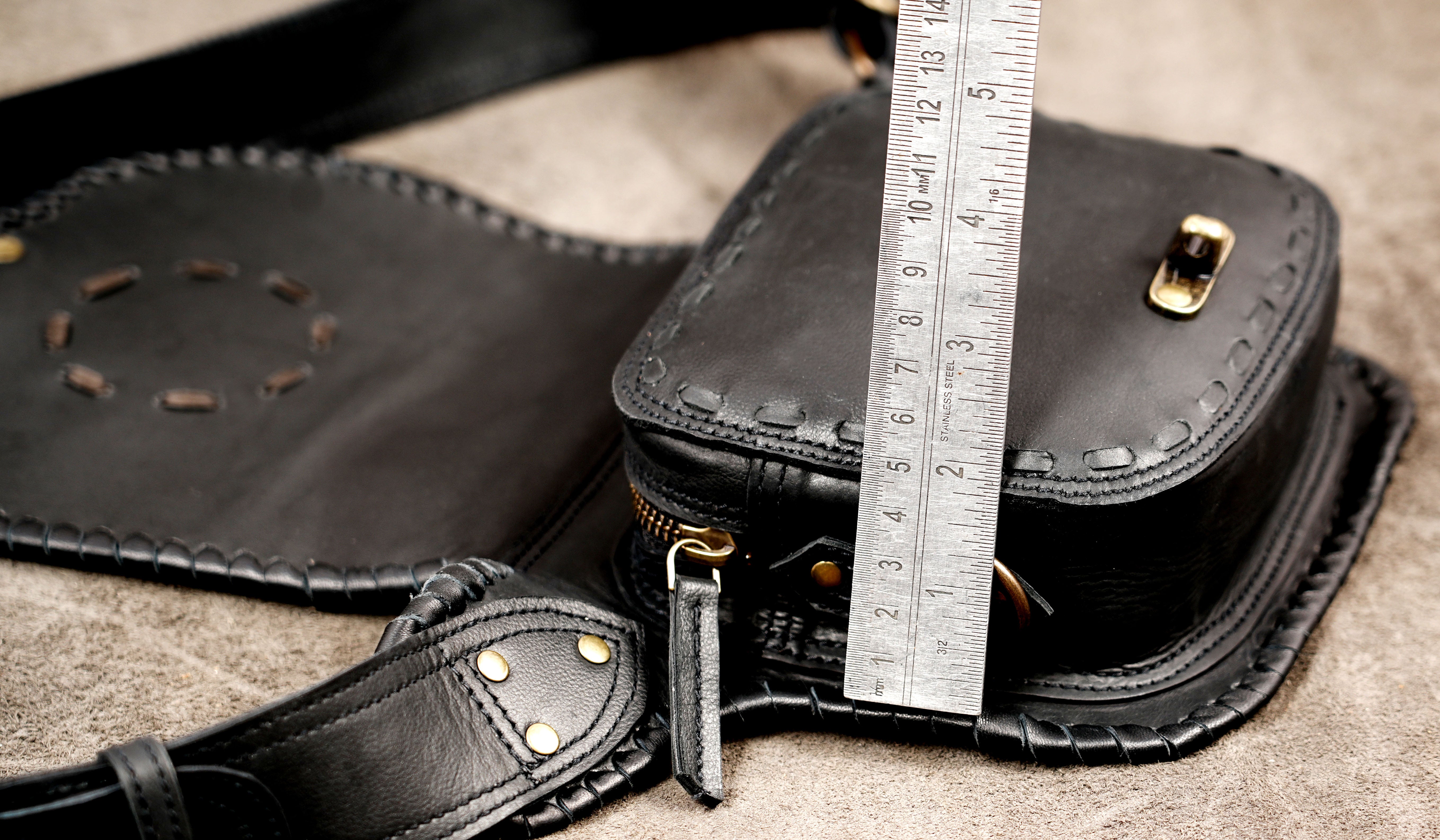 Black leather pouch bag with brass buckle