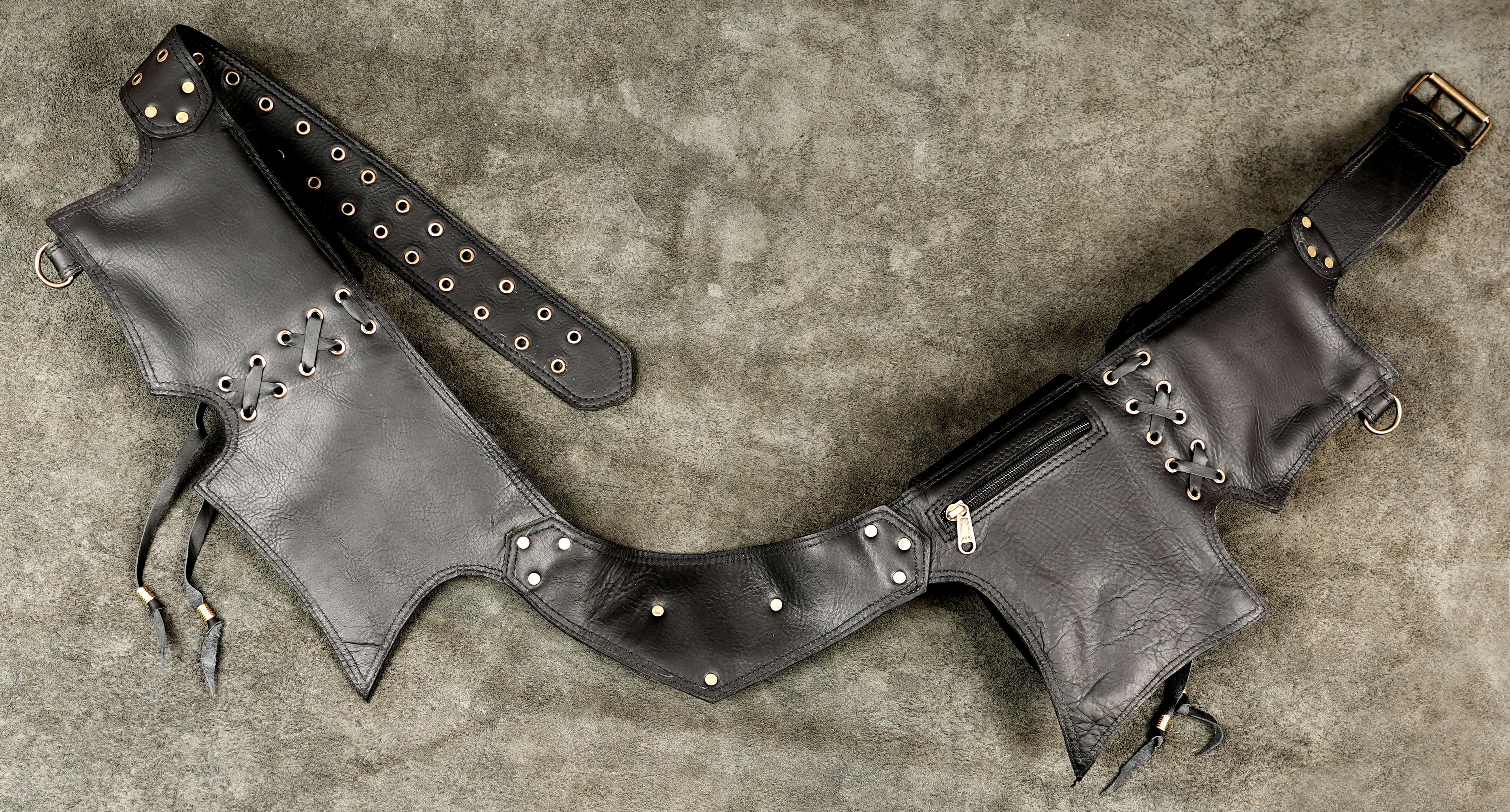 Distressed black leather belt bag with brass hardware accents