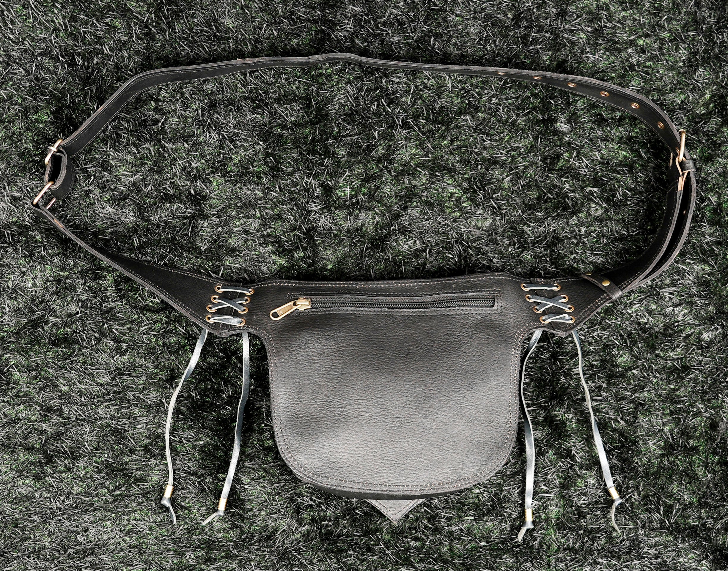 Black leather fanny pack with labradorite gemstone, adjustable belt and handcrafted detailing.