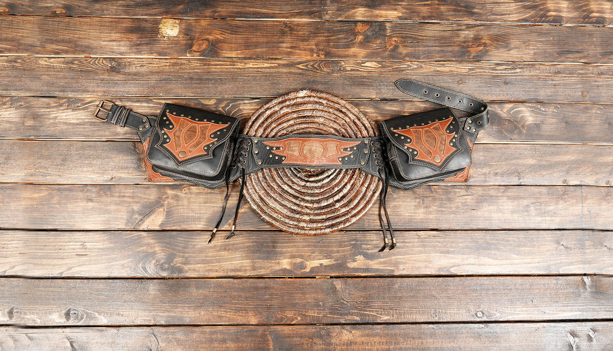 Handmade black leather utility belt bag with brown tooled leather details and two side pouches