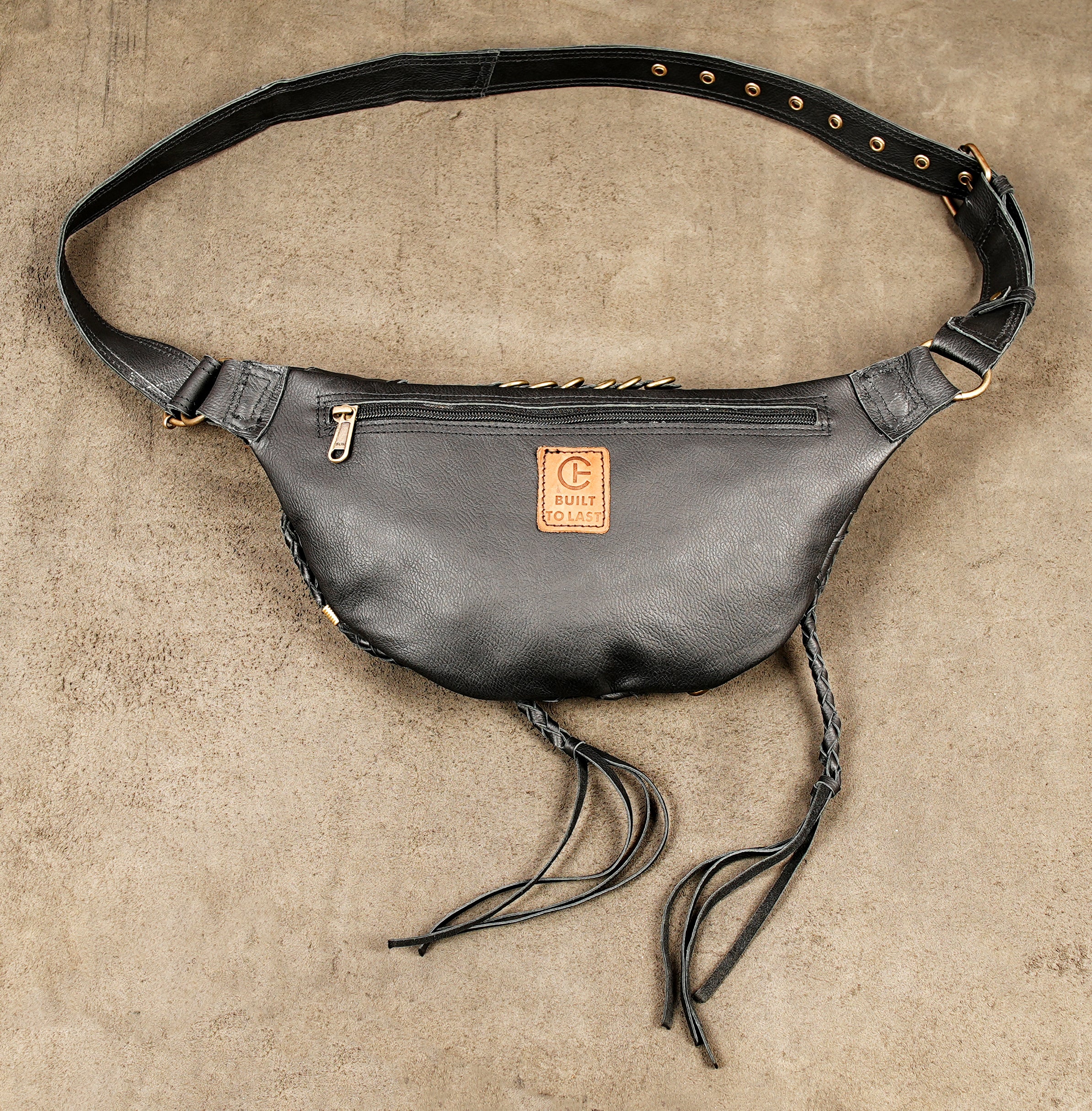 Adjustable black leather waist holster bag with three front zippers and gold stud decorations.