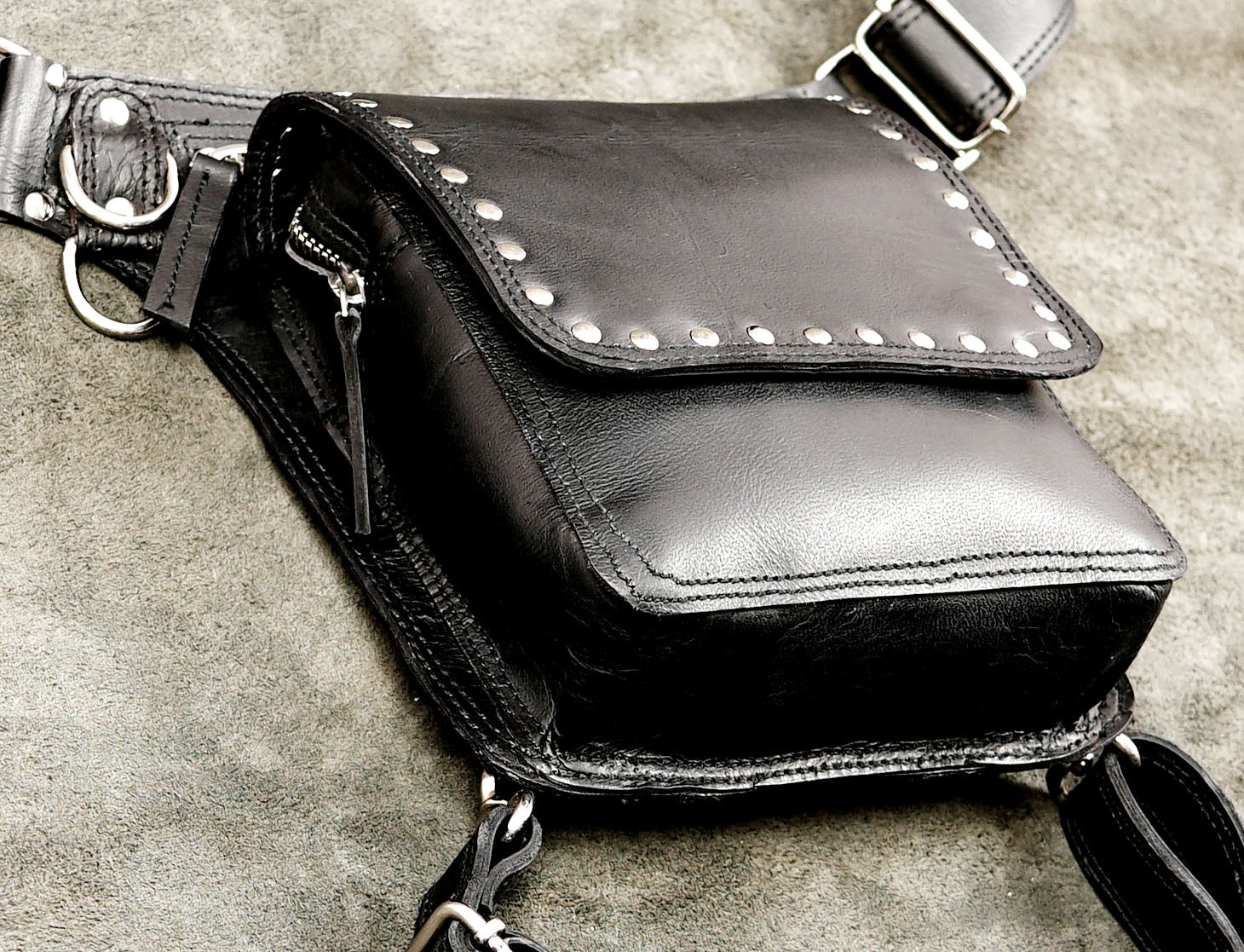 Black leather hip holster bag featuring silver studs and dual straps.