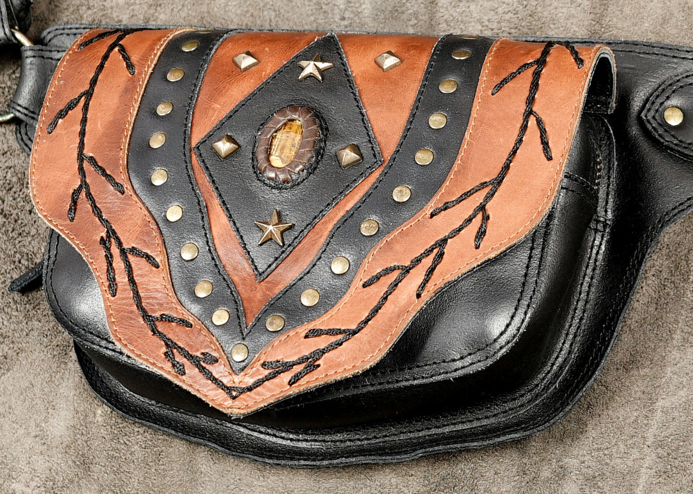 Black and tan tooled leather fanny pack with star conchos