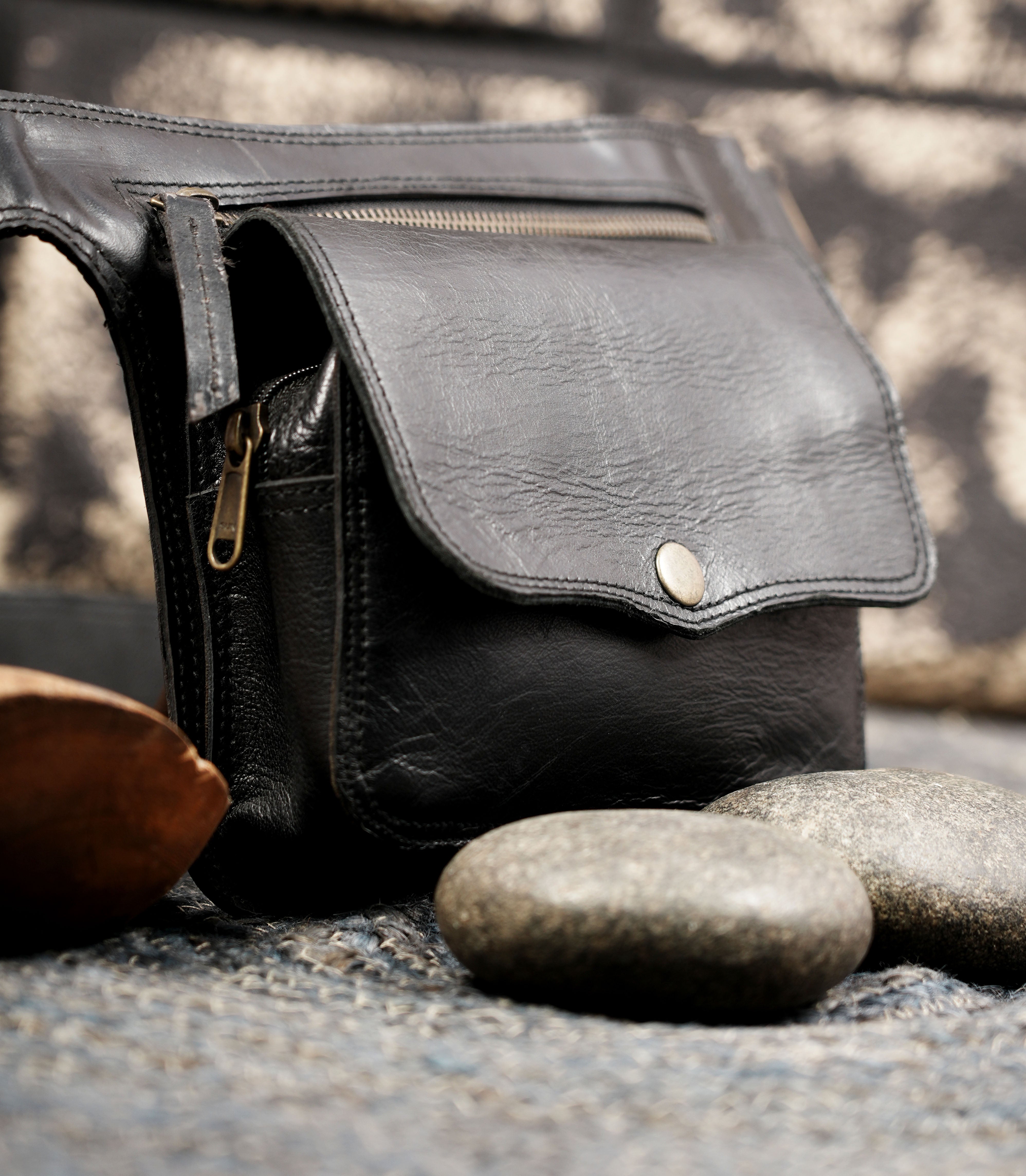 Adjustable black leather belt with attached waist pouch