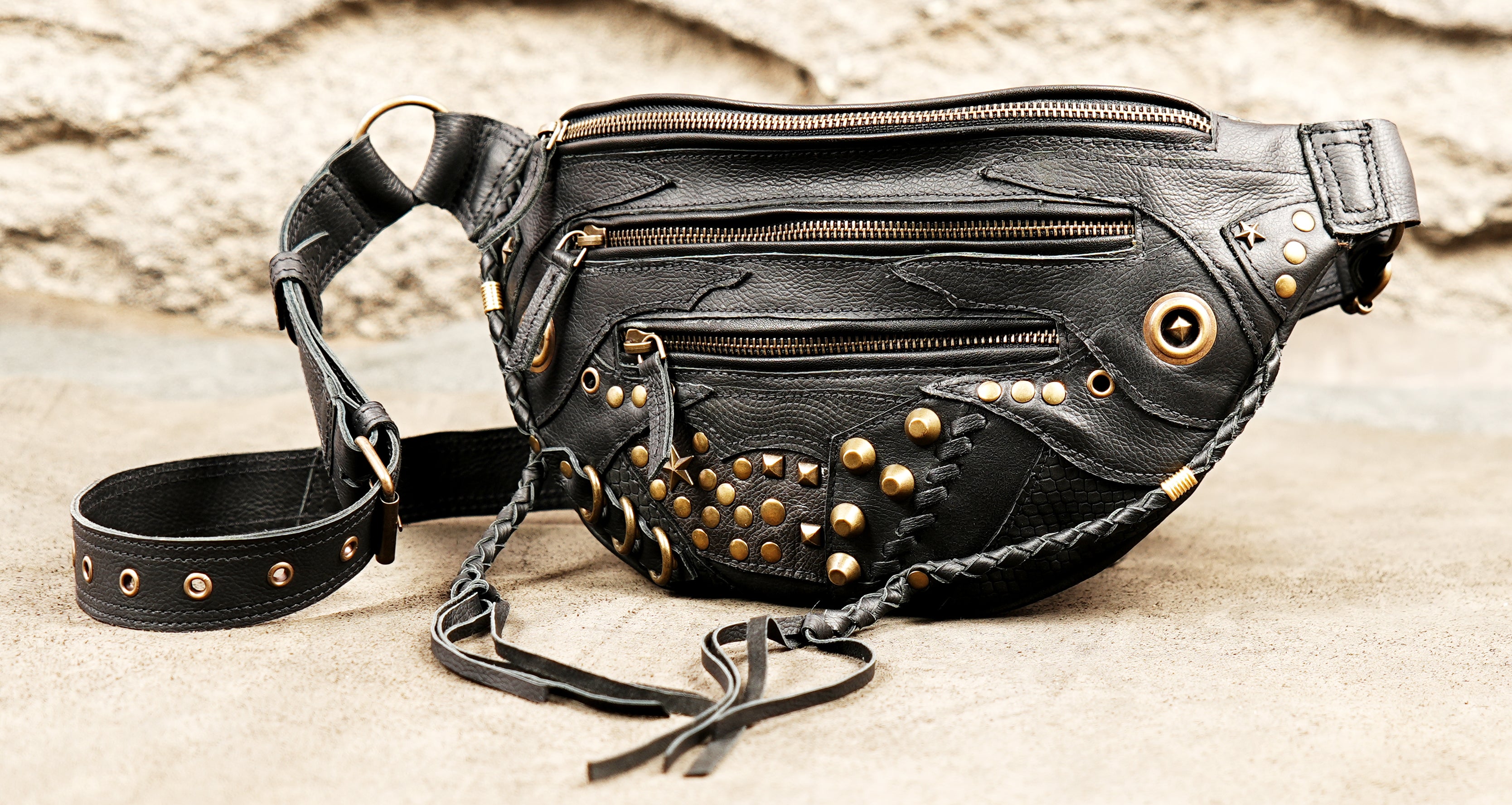Gothic punk black leather hip bag with multiple zipper pockets and gold metal embellishments.