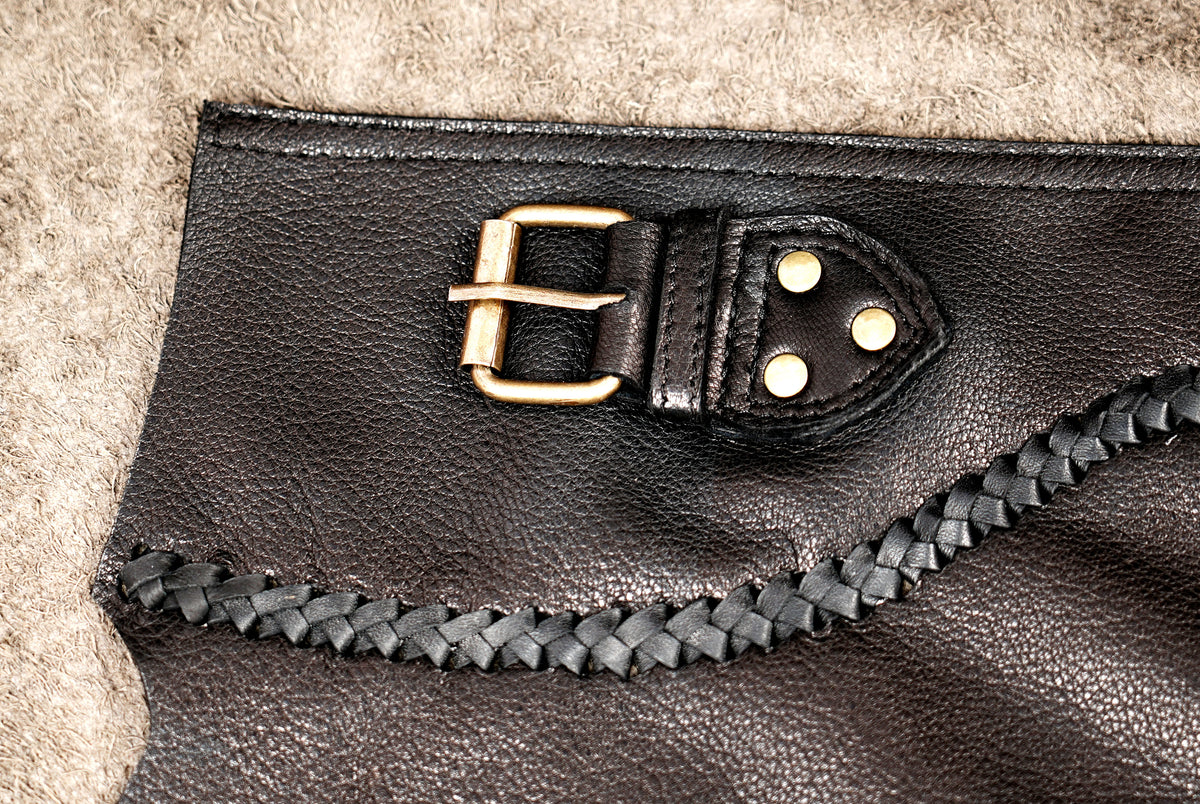Asymmetrical leather wrap skirt with decorative stitching and studs