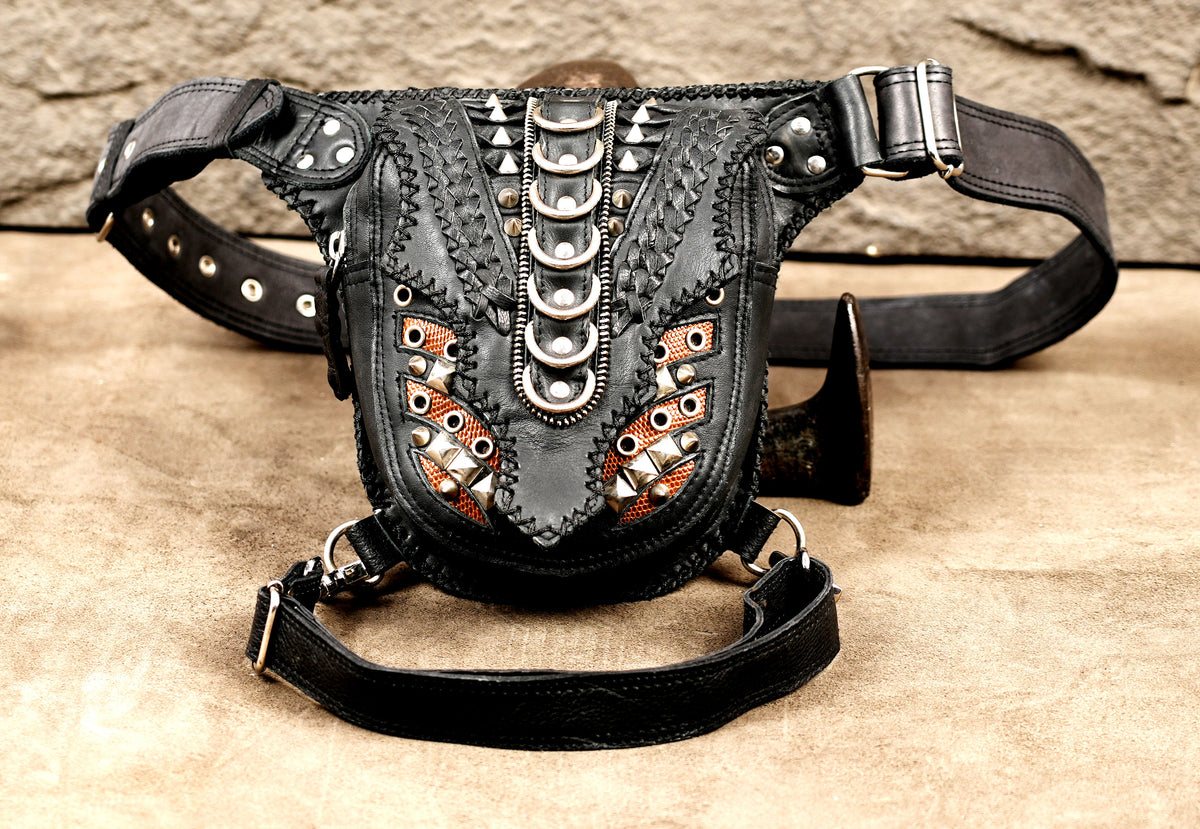 Front view of leather drop leg bag with copper mesh panels