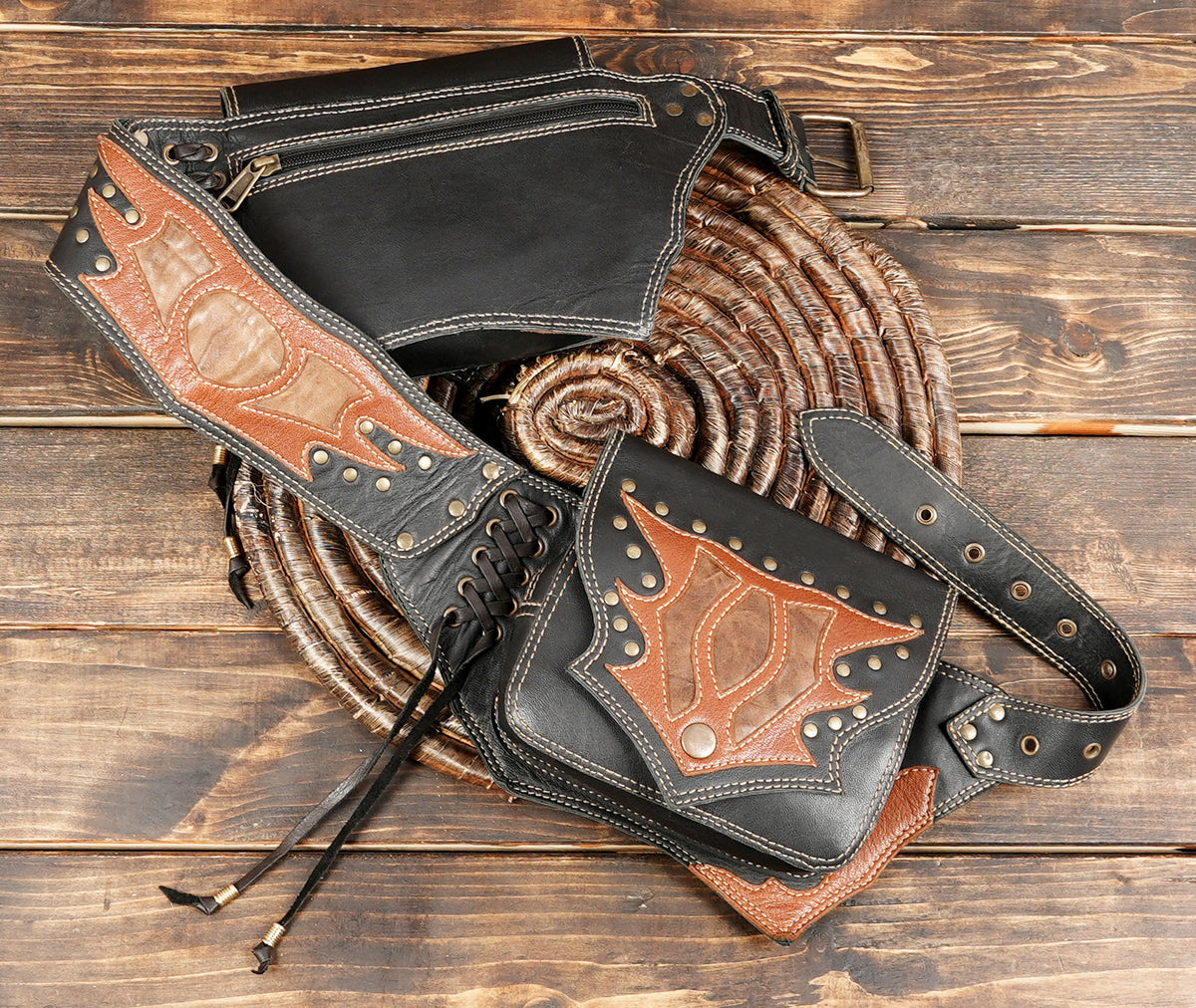Leather hip belt with two side bags, decorative tooling, and adjustable buckle closure