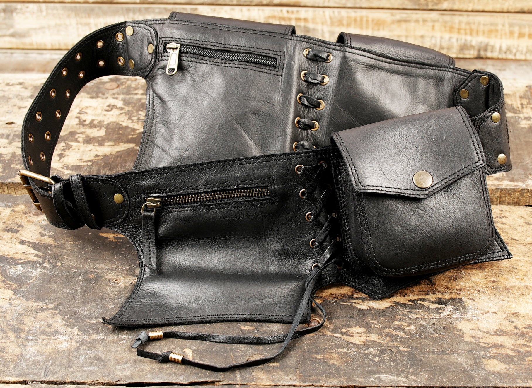 Medieval style black leather utility belt featuring snap pockets and an adjustable wide strap.