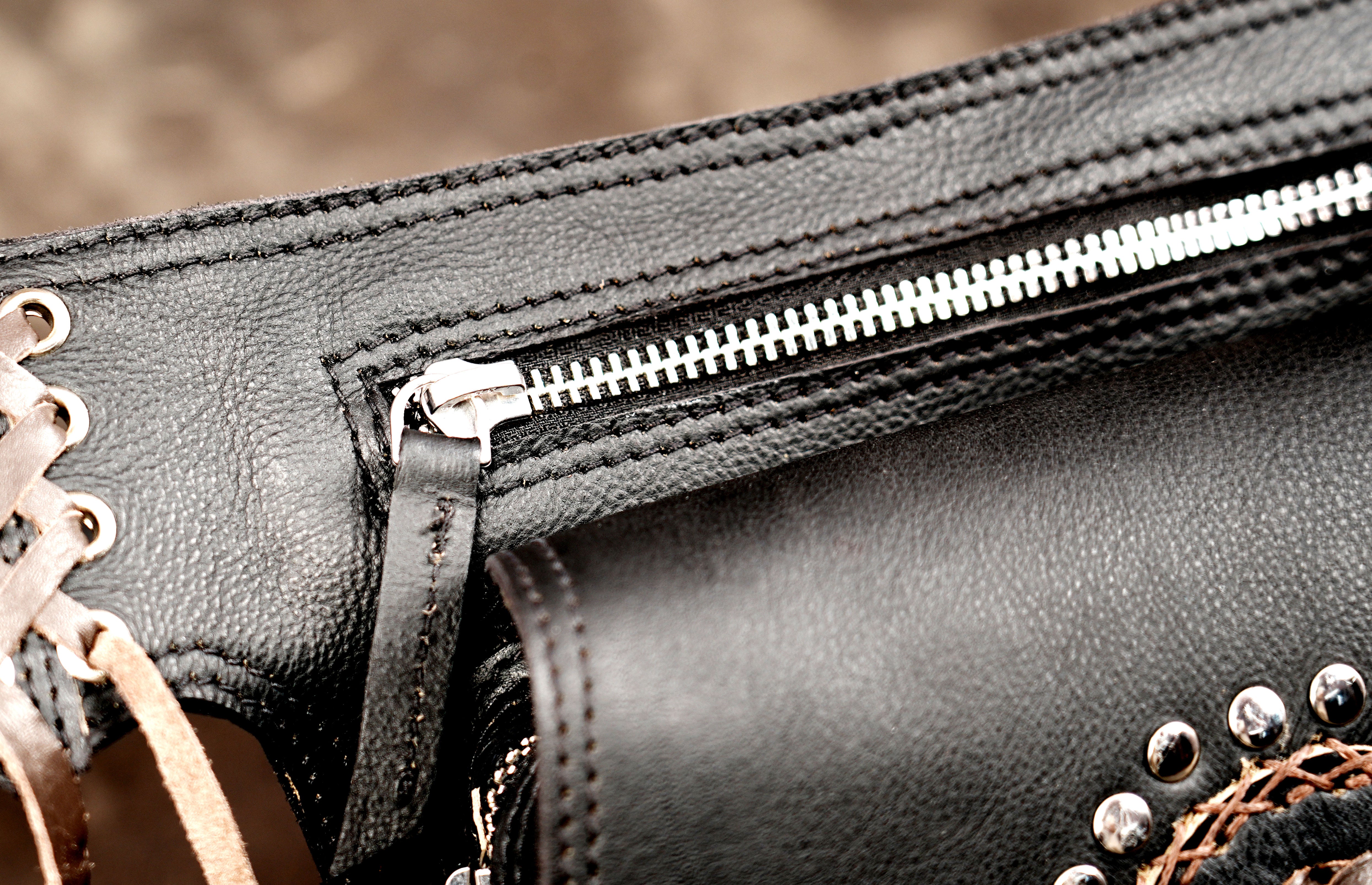 Alternative fashion black leather pocket belt with zippered pouch and stone detailing.