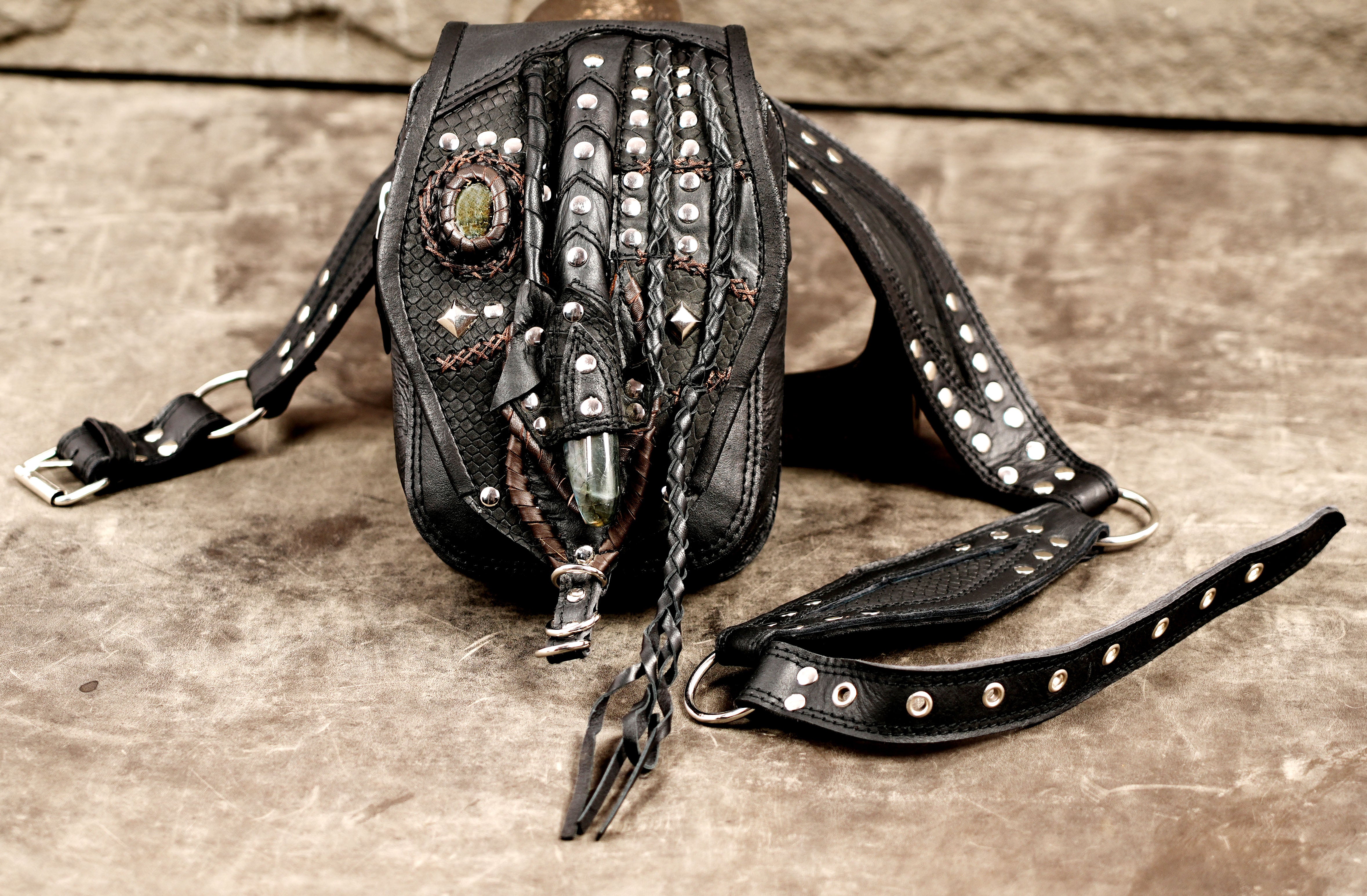 Leather hip bag with adjustable belt and decorative gemstone closure