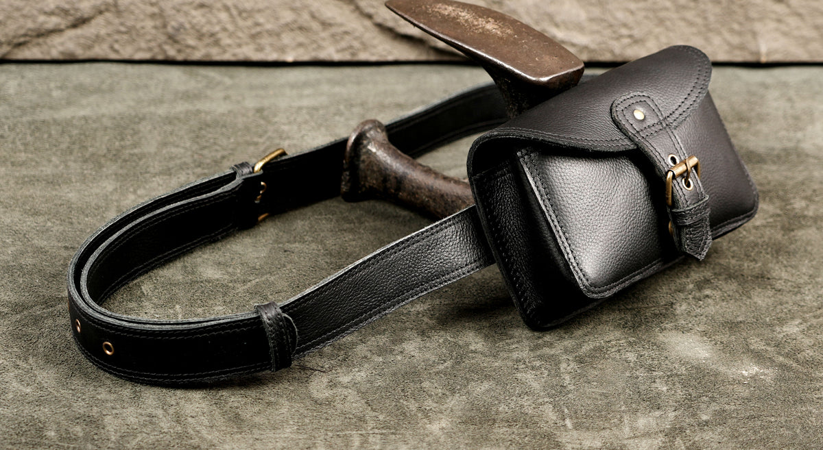 Black leather crossbody and waist bag with brass buckle detail