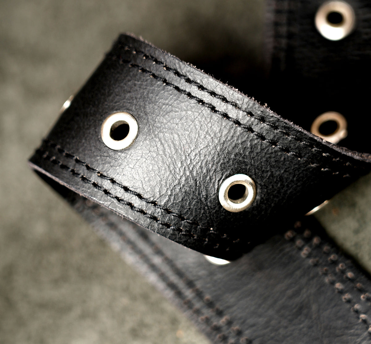 Adjustable leather leg pouch with clip strap detail