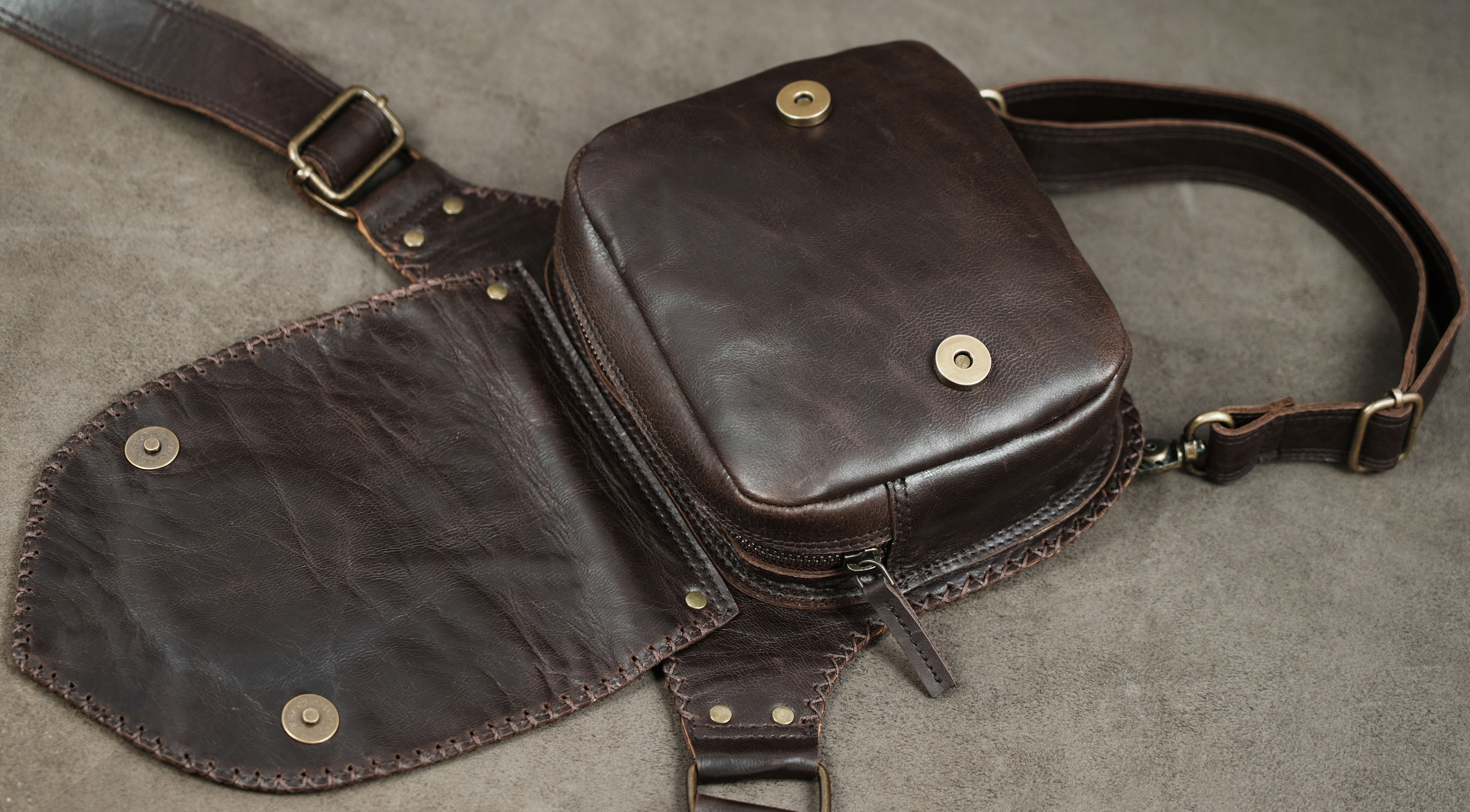 Artisan-made leather thigh pouch with antique brass fittings
