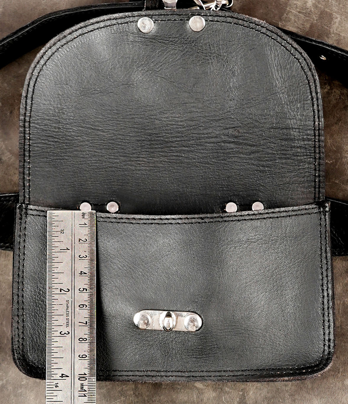 Black leather crossbody pouch with elegant silver clasp