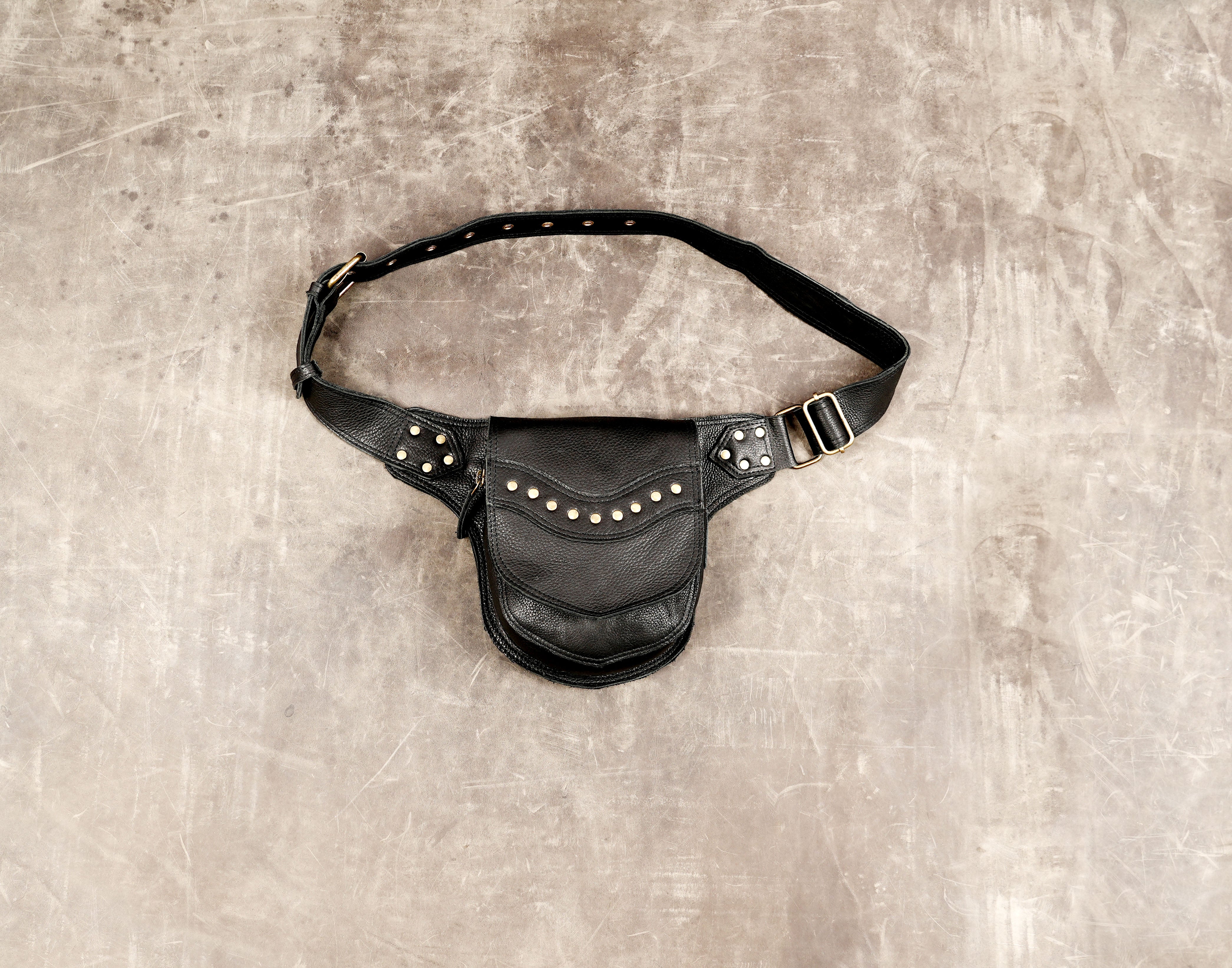 Black leather hip pouch with adjustable belt and antique brass hardware