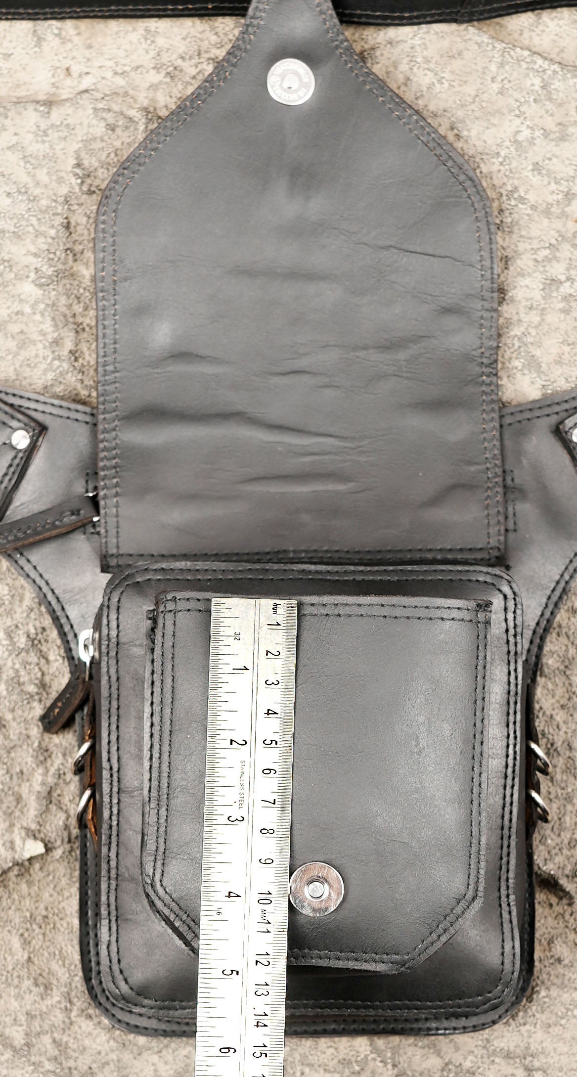 Black leather travel bag with zip top and stud accent