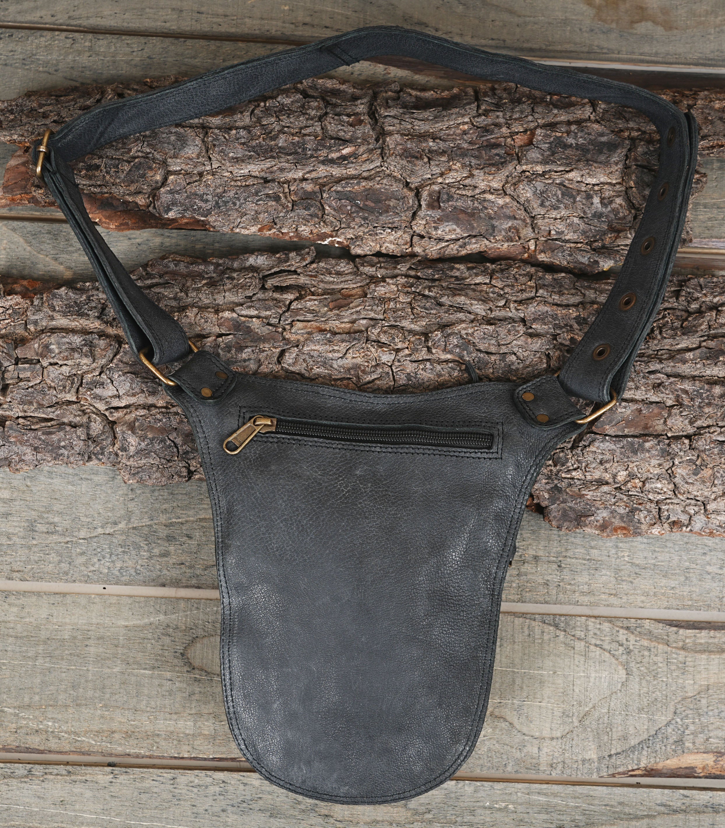 Black leather utility pouch with zip top and adjustable buckle strap