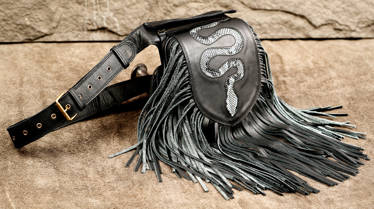 Black leather fringe bag with a snake print patch on the front.