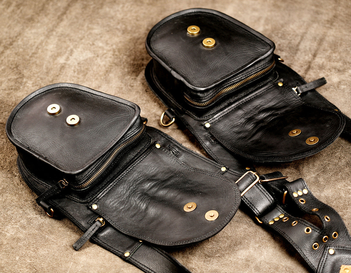 Gothic festival leather harness with two holster pockets and decorative flame-pattern accents.