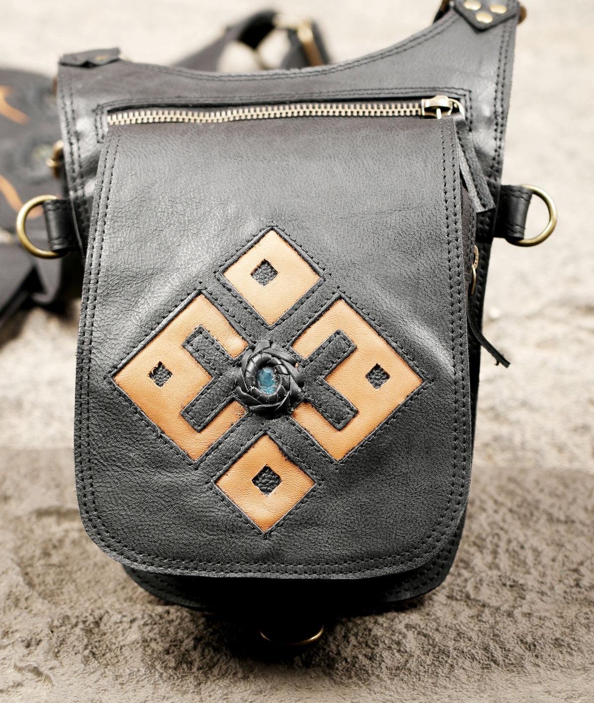 Black leather steampunk shoulder holster bag with geometric details