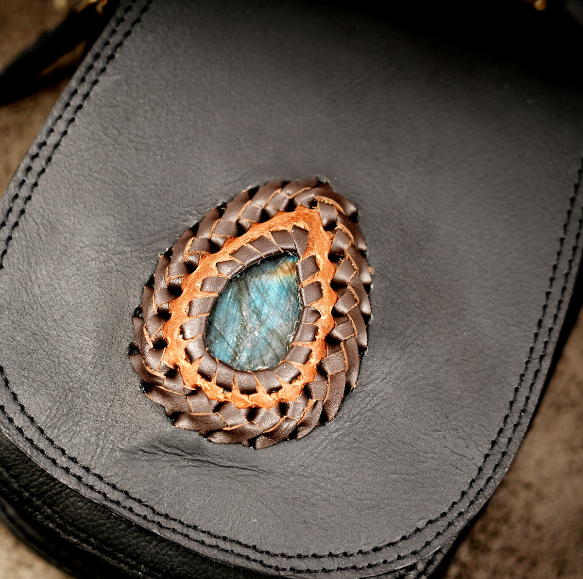 Black leather festival bag with teardrop gemstone decorations and metal buckles