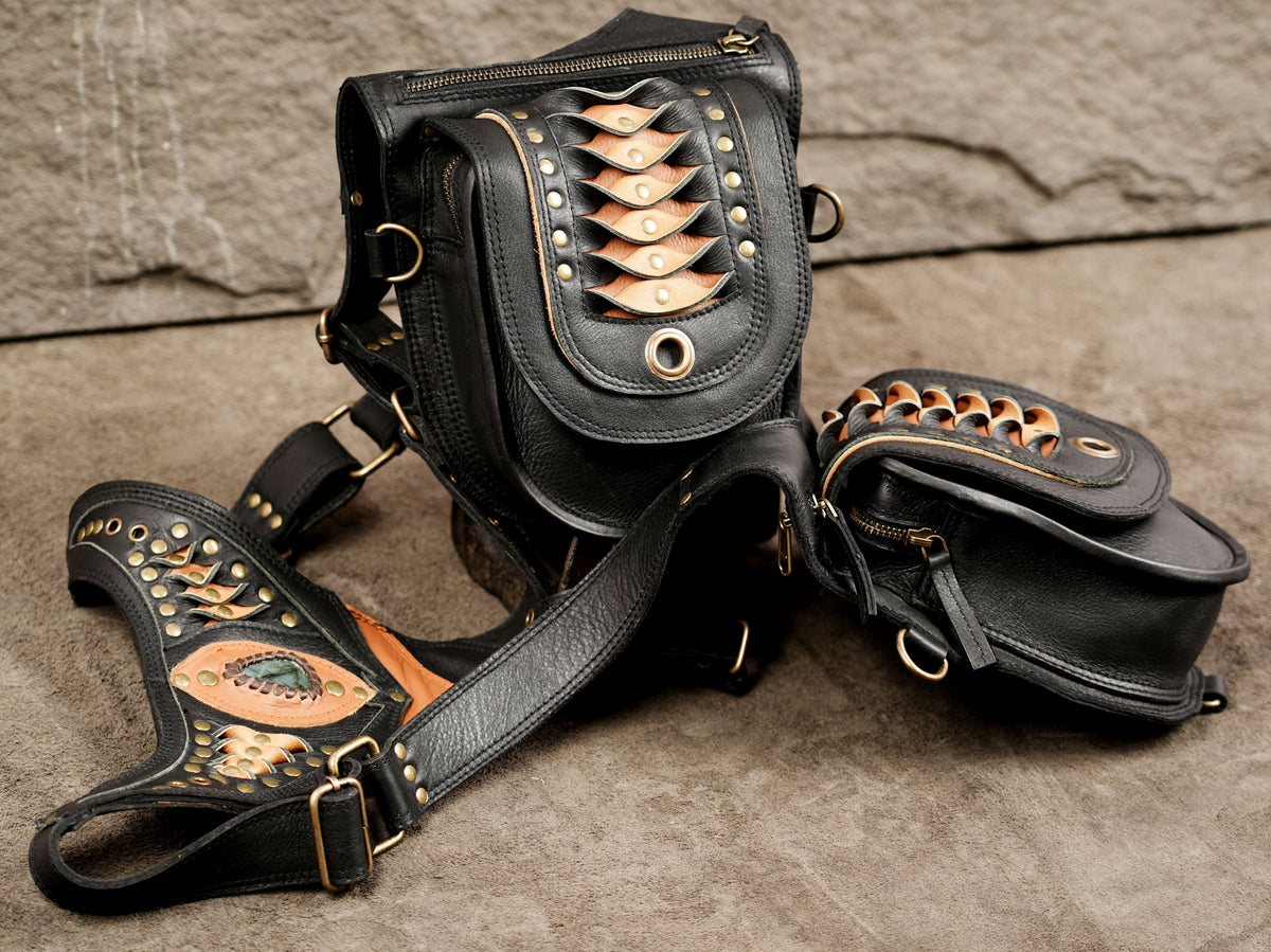 Black leather festival harness bag with dual pouches and orange flame-style leather accents.