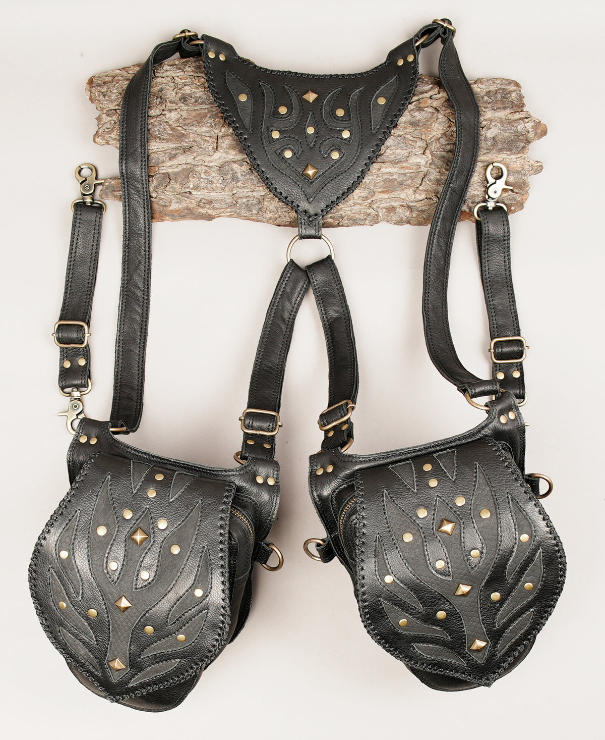 Black leather harness-style bag set with two large pouches and a matching triangular top panel.