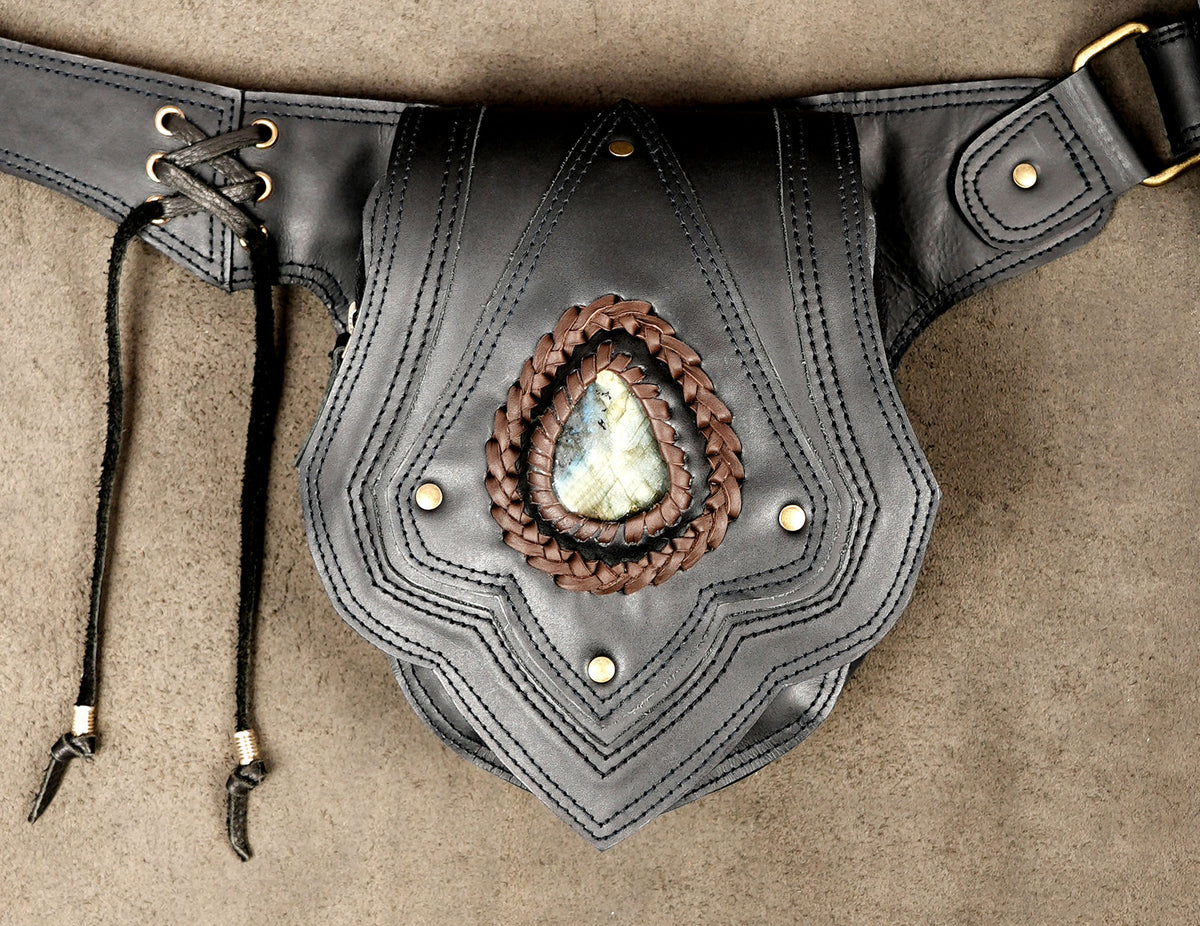 A black leather belt pouch with decorative stitching, a braided brown leather border, and a central teardrop-shaped natural stone inlay.