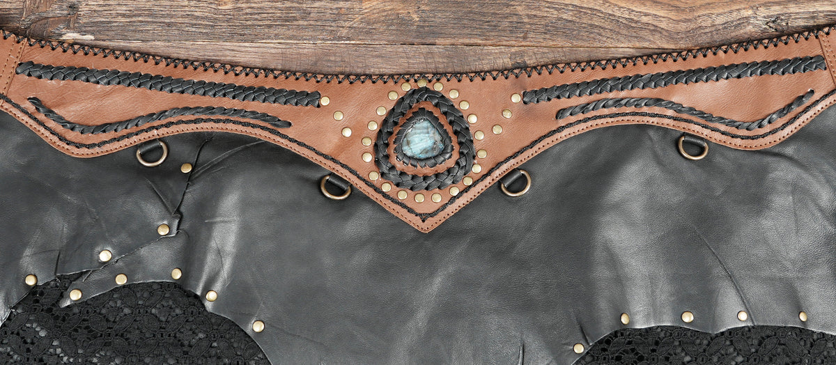 Boho leather mini skirt with studded waist, flat lay view