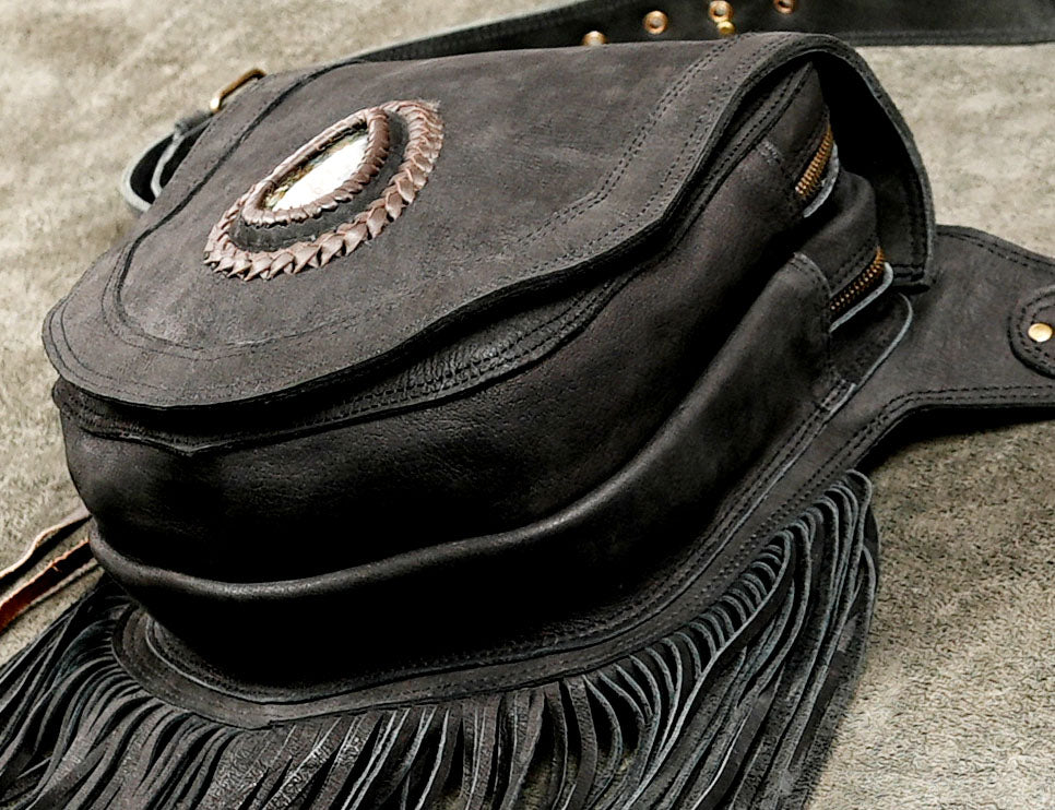 Boho suede waist bag on gray background
