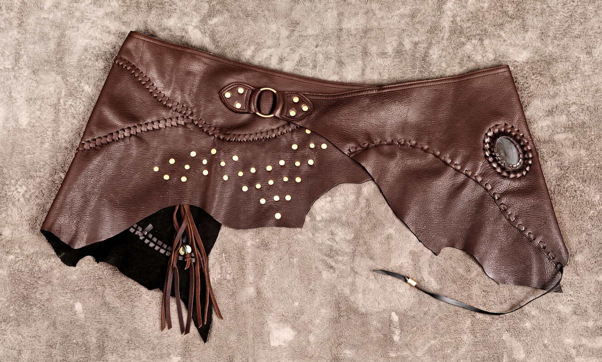 Gothic black leather hip skirt with brass stud pattern