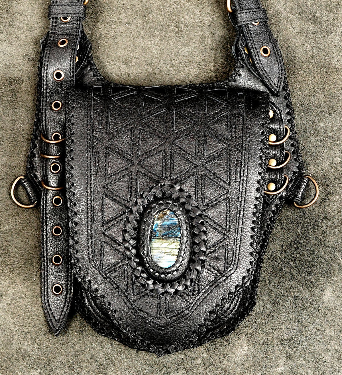 Braided leather chest holster with double pouches, flat lay