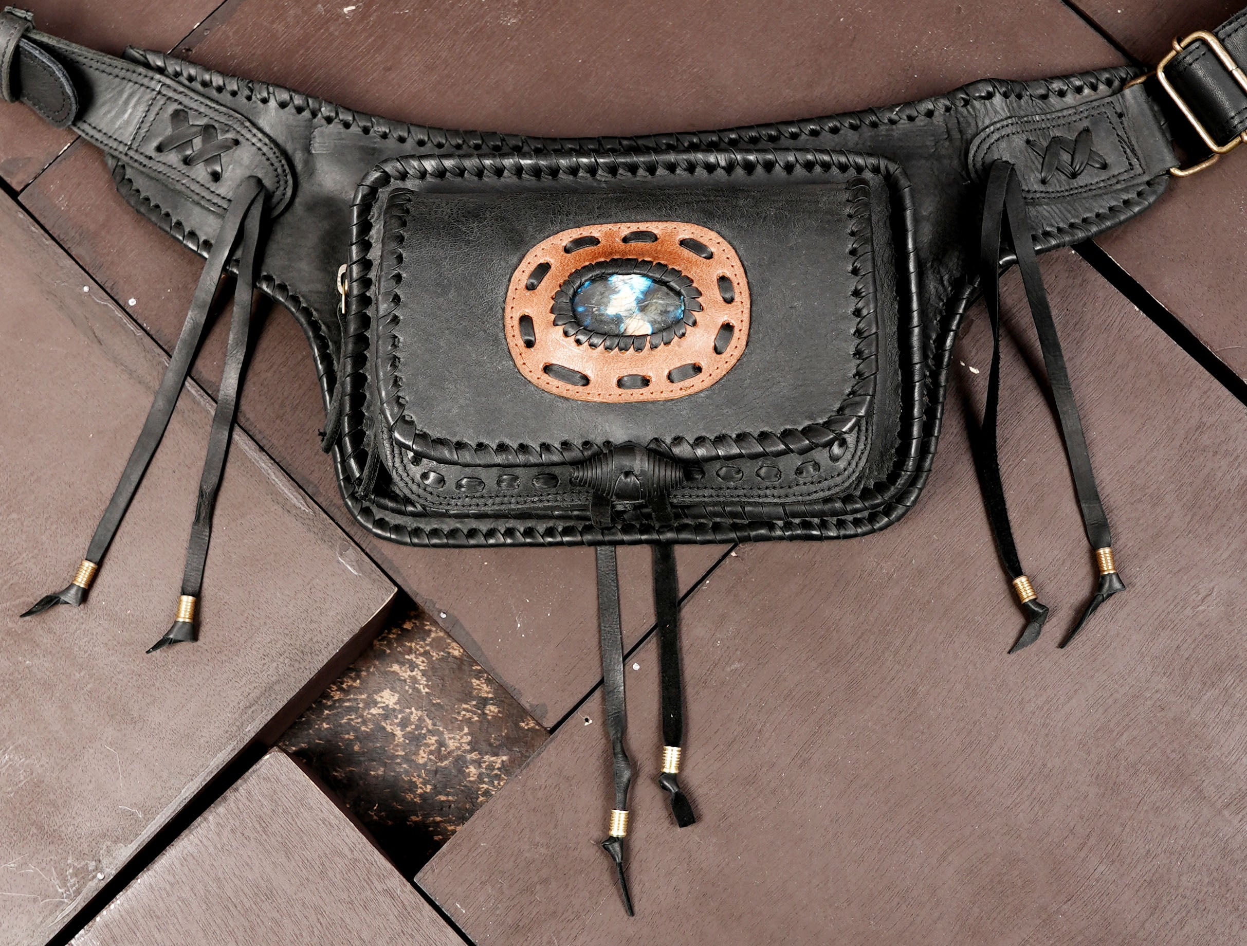 Braided leather waist bag with gemstone medallion, flat lay view